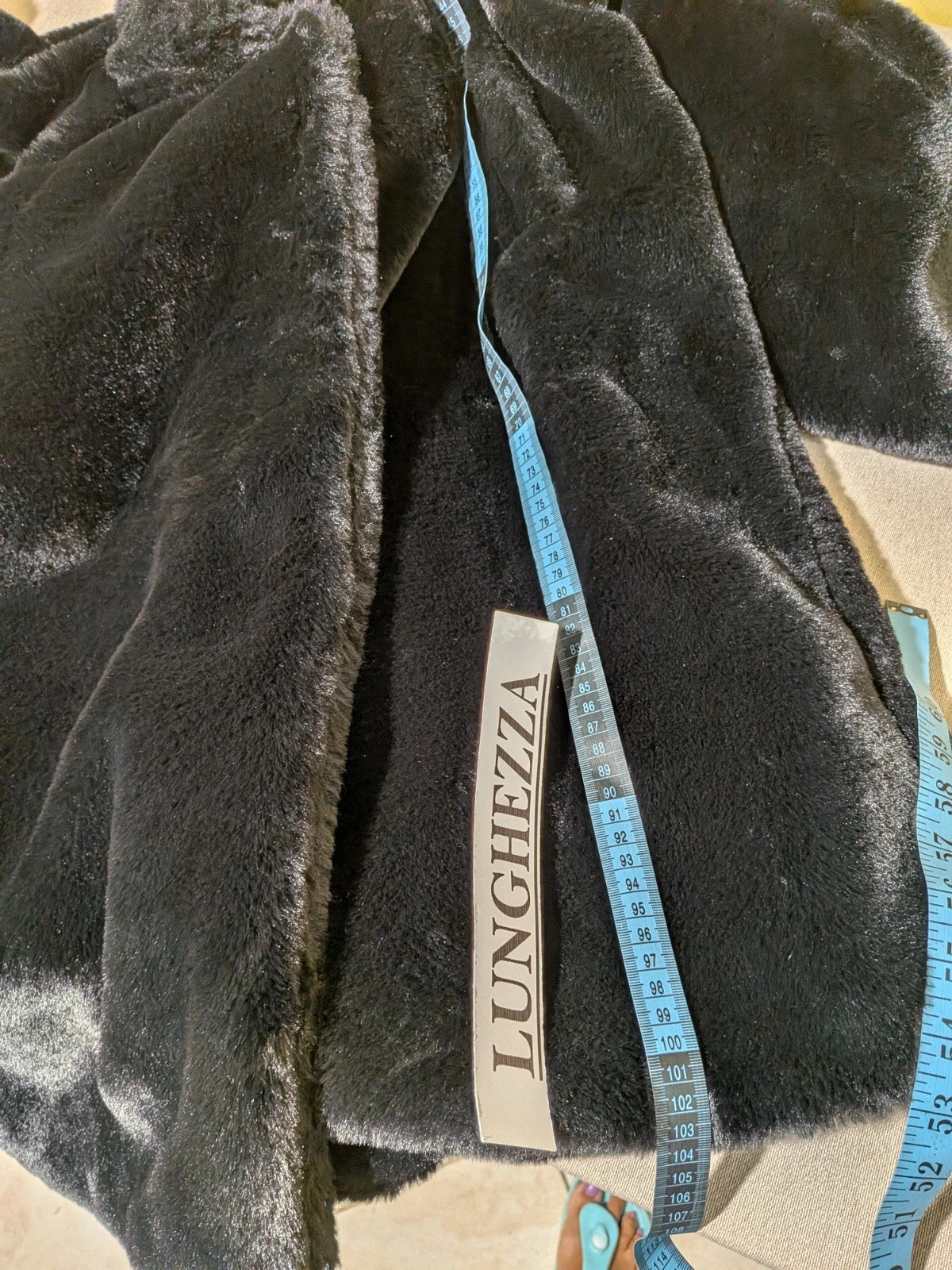Zuiki black teddy coat with wide lapel, side pockets, and soft faux fur material.