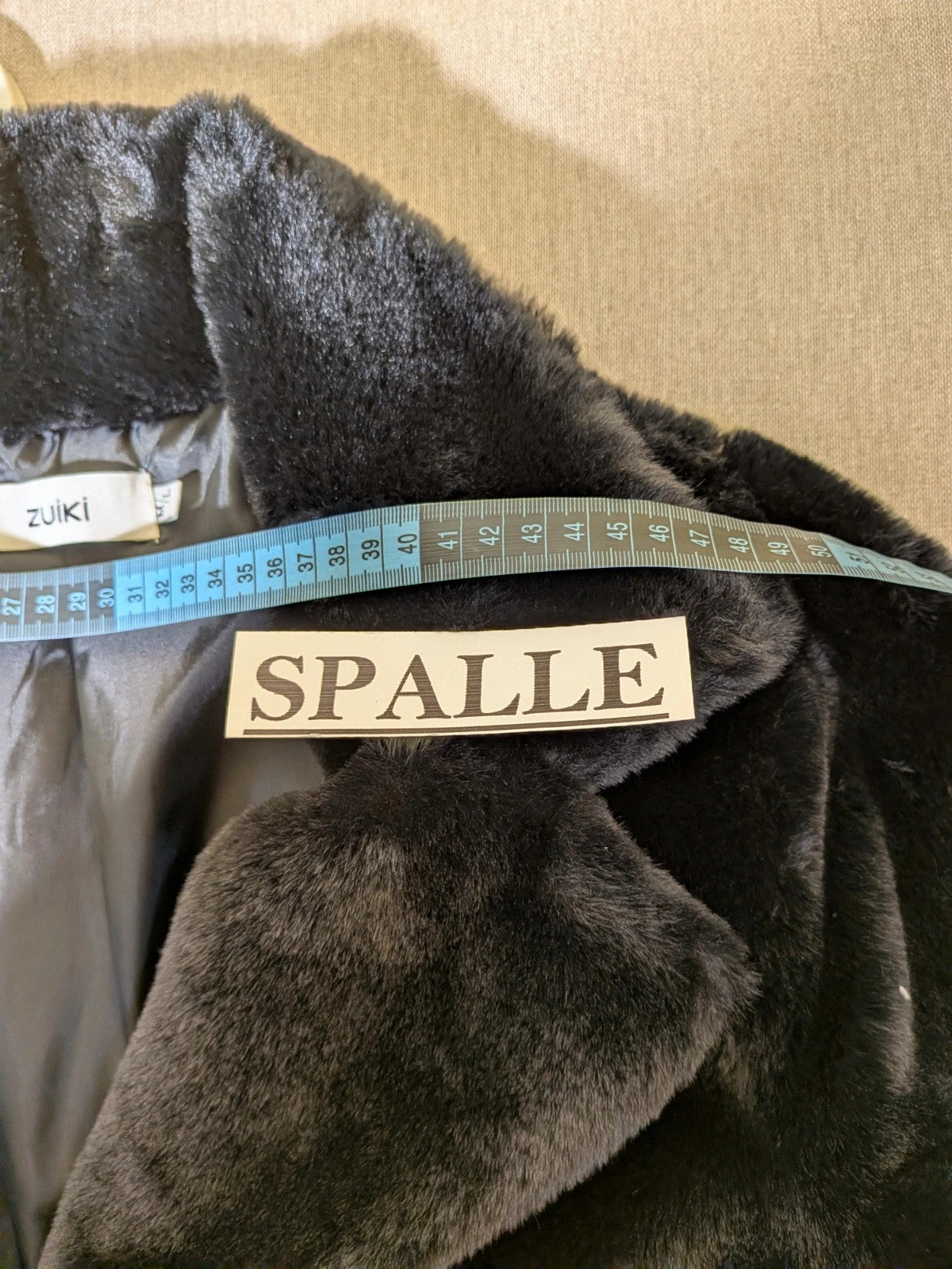 Zuiki black teddy coat with wide lapel, side pockets, and soft faux fur material.