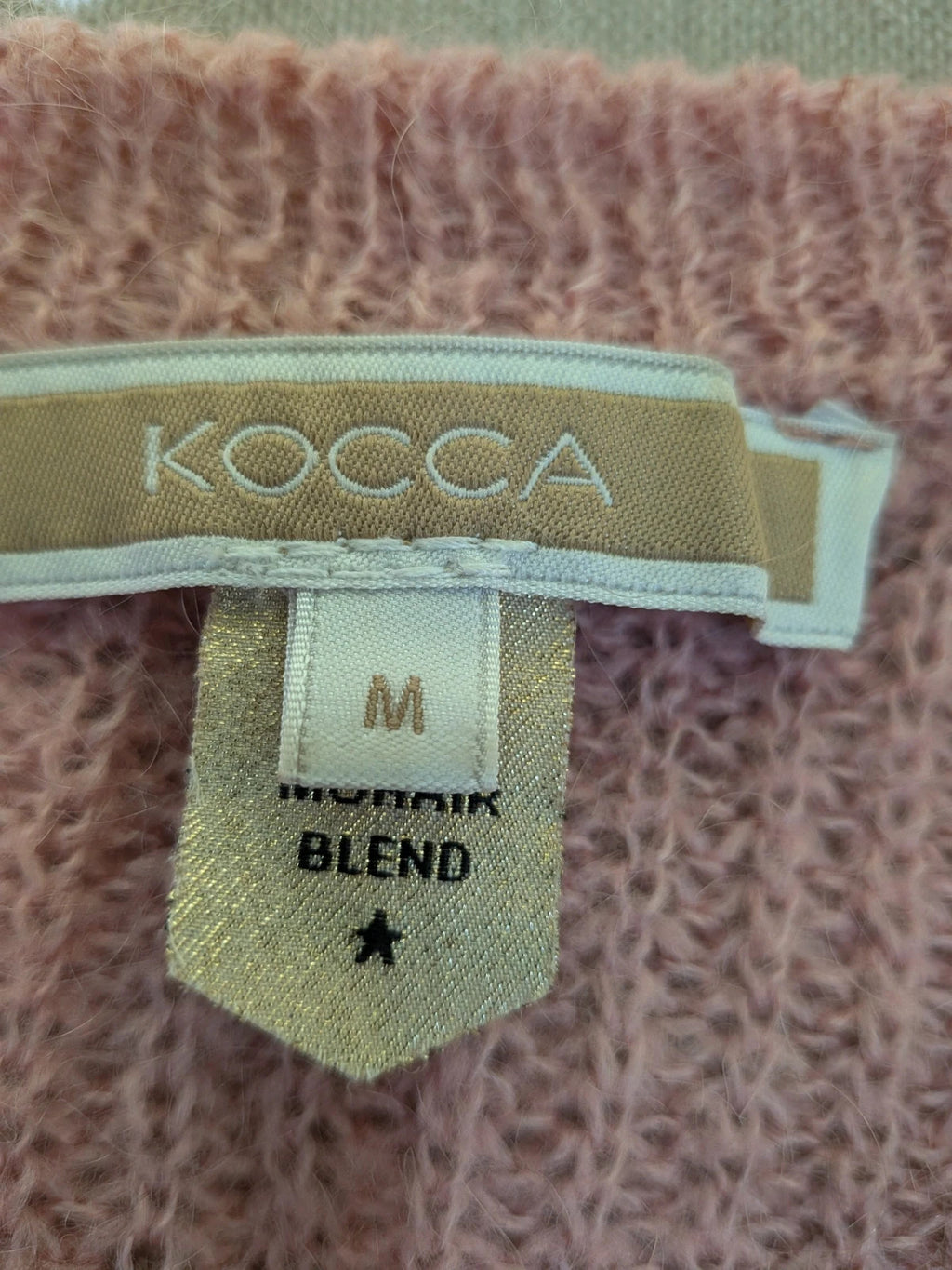 KOCCA pink sweater with balloon sleeves and metallic logo tag, made from mohair blend.