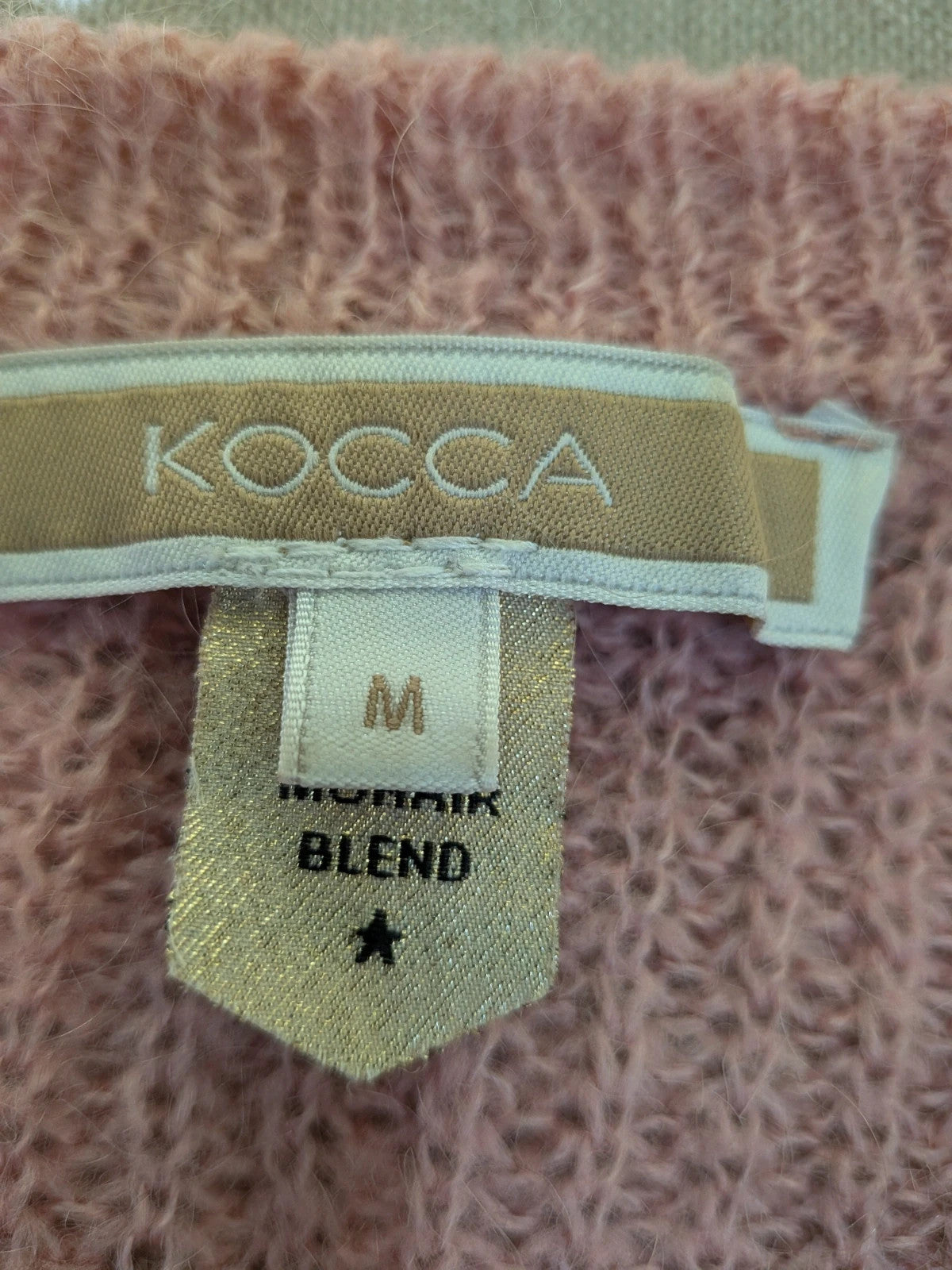 KOCCA pink sweater with balloon sleeves and metallic logo tag, made from mohair blend.