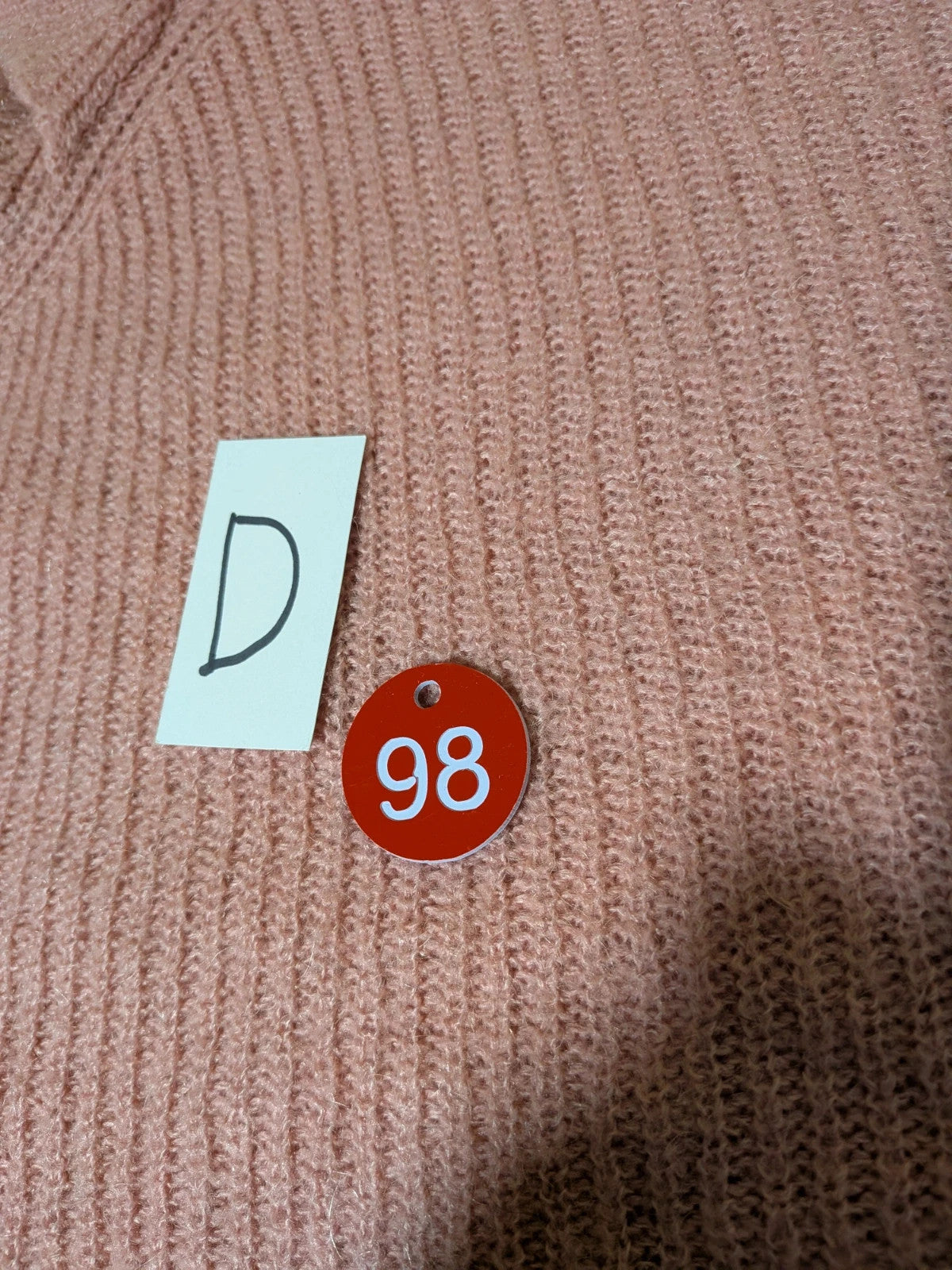 KOCCA pink sweater with balloon sleeves and metallic logo tag, made from mohair blend.