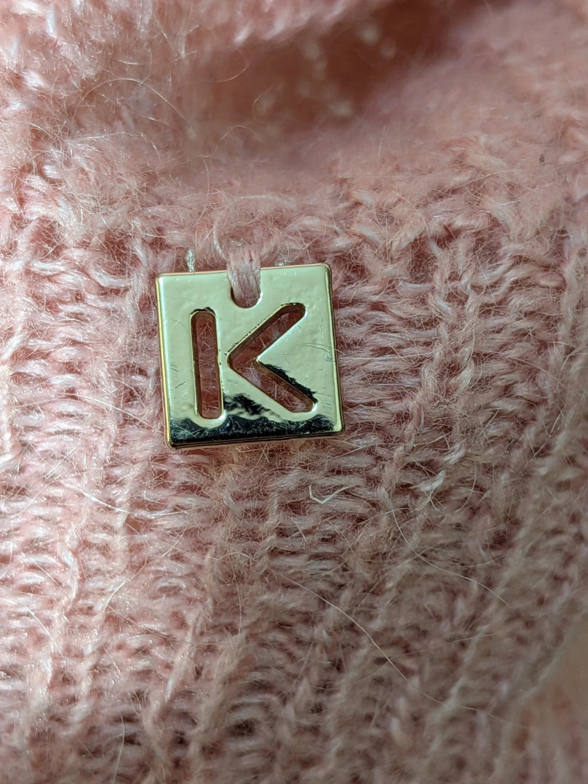 KOCCA pink sweater with balloon sleeves and metallic logo tag, made from mohair blend.