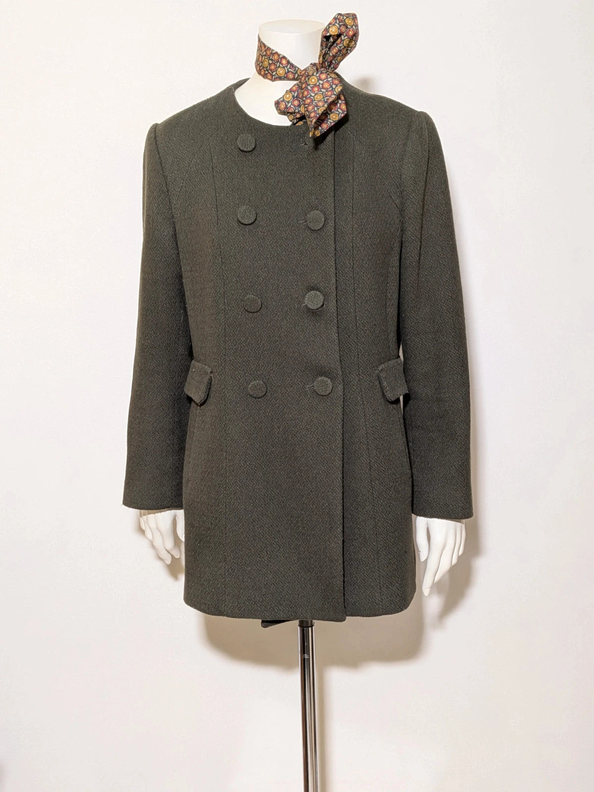 Conbipel green military coat double-breasted design with decorative flaps and covered buttons.