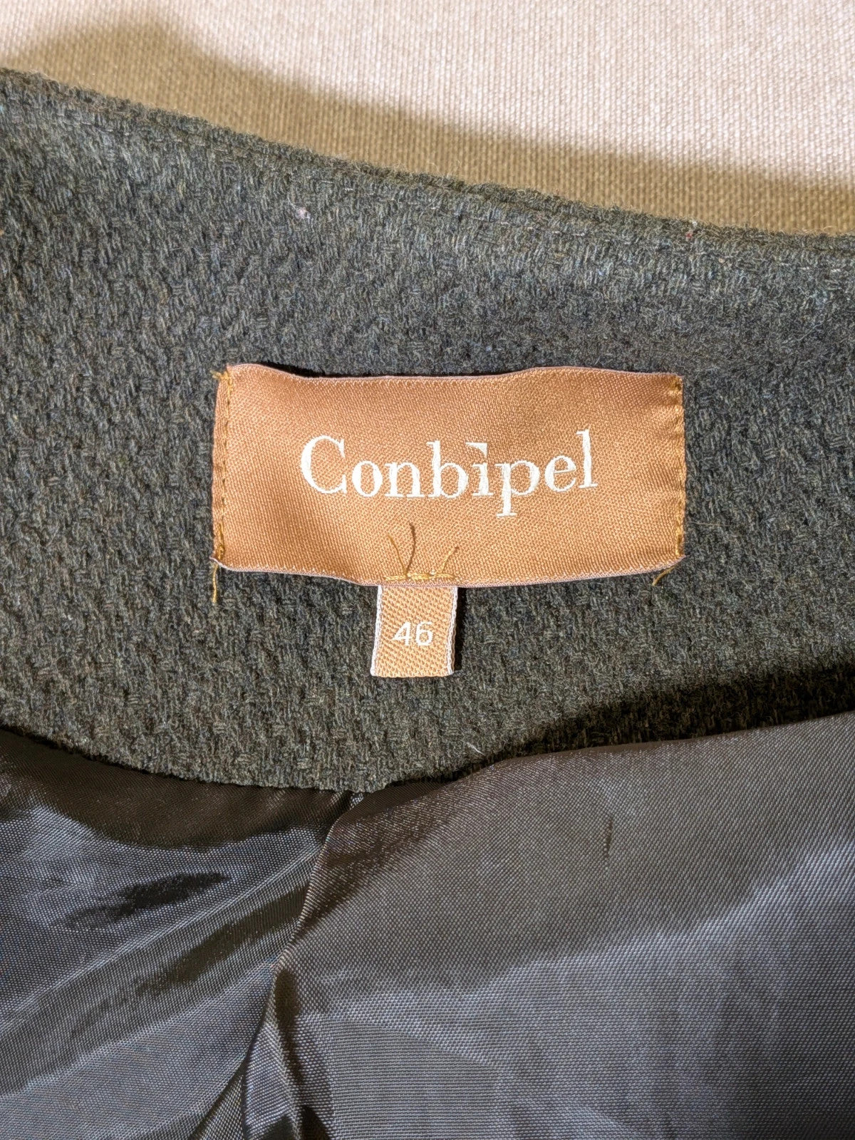 Conbipel green military coat double-breasted design with decorative flaps and covered buttons.