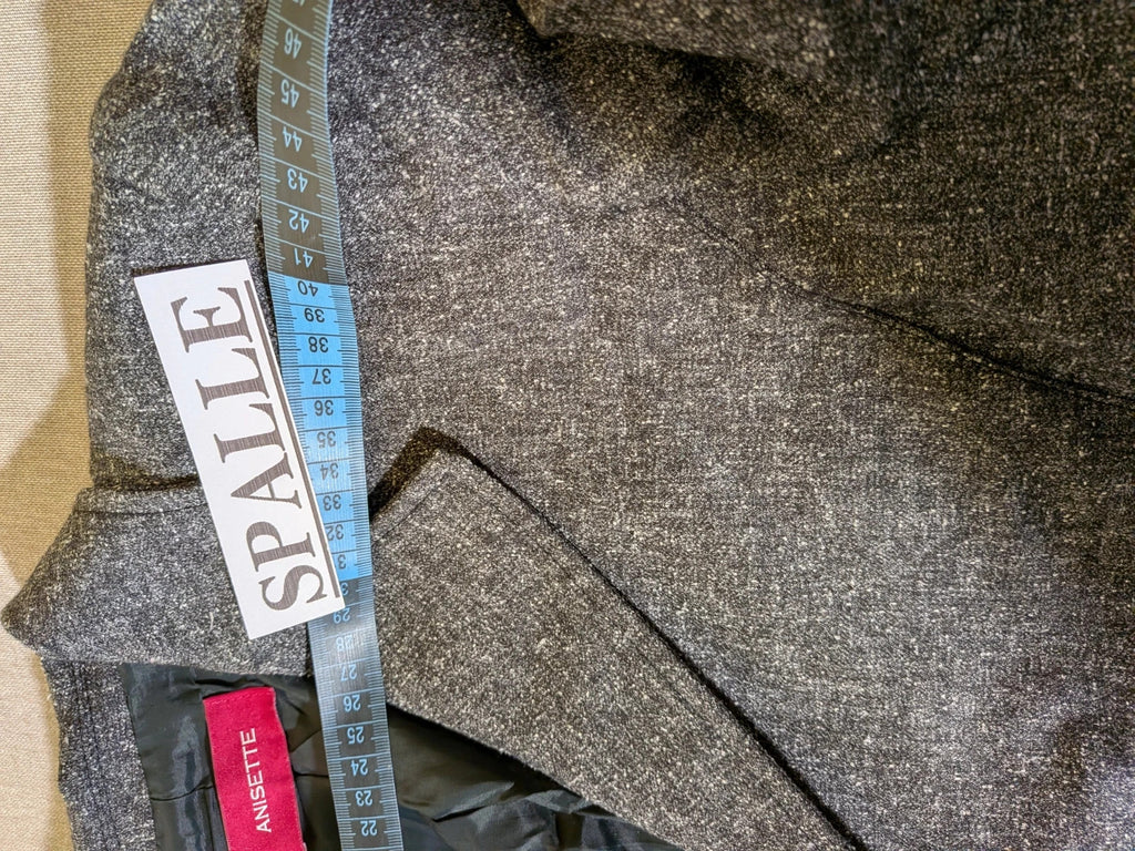 Anisette grey skirt suit with three-button blazer and knee-length skirt, tweed texture.