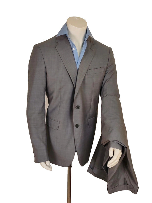 Enrico Coveri grey tailored suit with structured jacket, classic lapels, and micro-pattern.