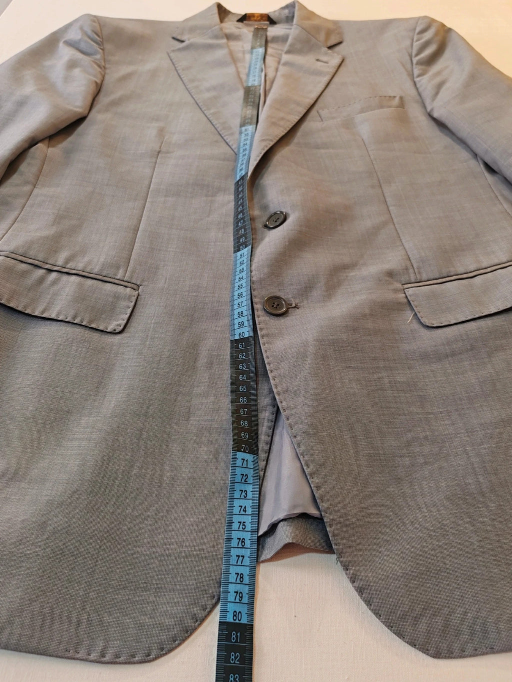 Enrico Coveri grey tailored suit with structured jacket, classic lapels, and micro-pattern.