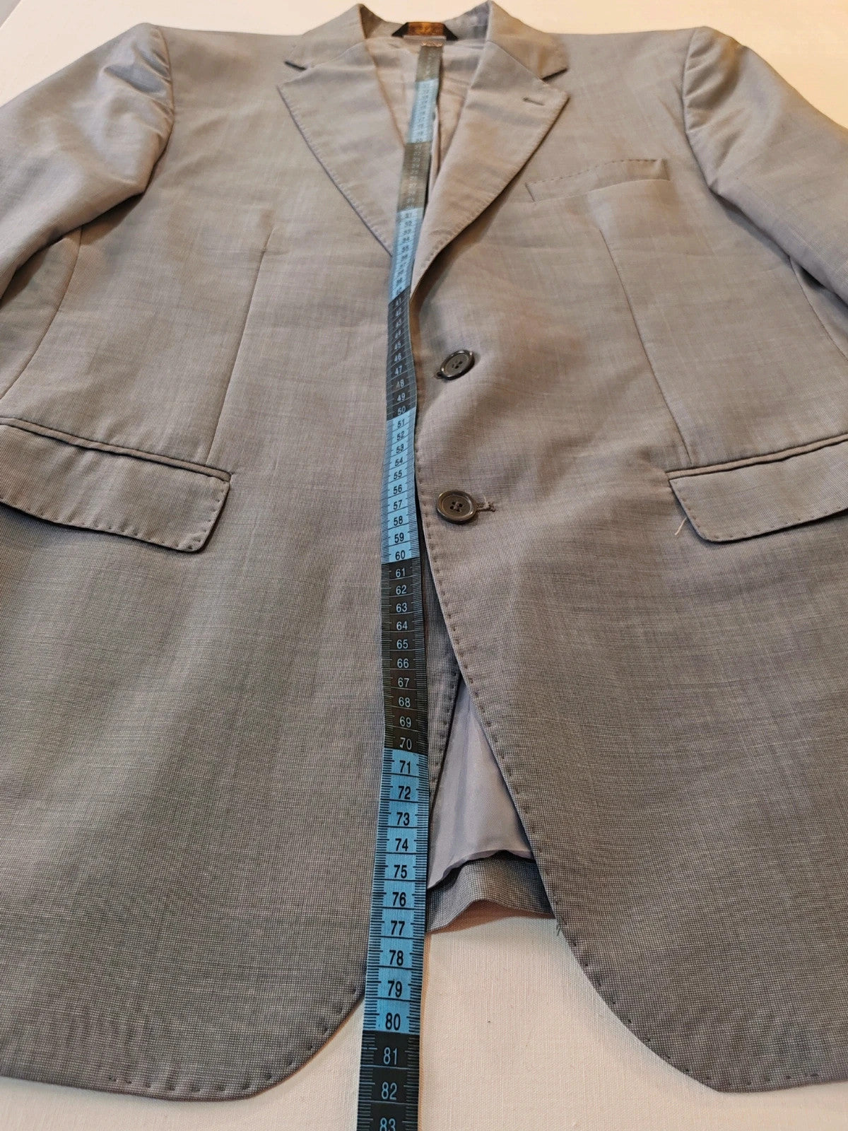 Enrico Coveri grey tailored suit with structured jacket, classic lapels, and micro-pattern.