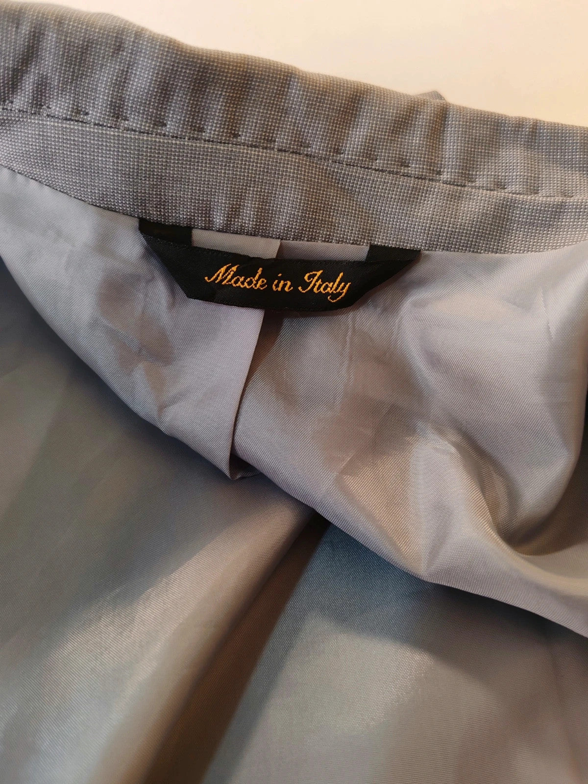 Enrico Coveri grey tailored suit with structured jacket, classic lapels, and micro-pattern.