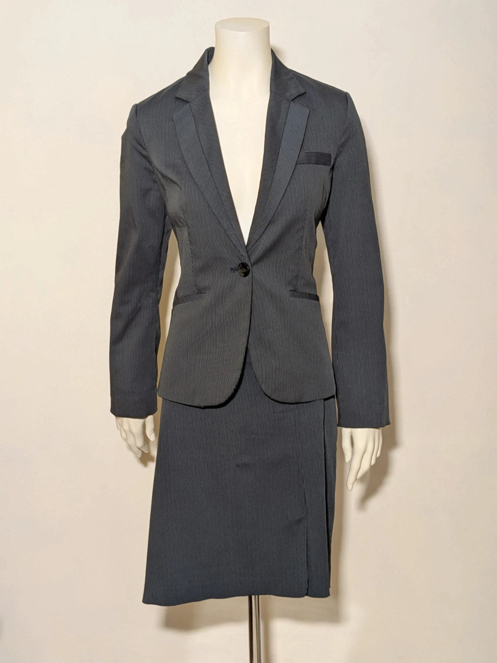 Mango Suit grey skirt suit with pinstripe pattern, single-button blazer, elegant pencil skirt.