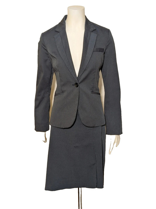 Mango Suit grey skirt suit with pinstripe pattern, single-button blazer, elegant pencil skirt.