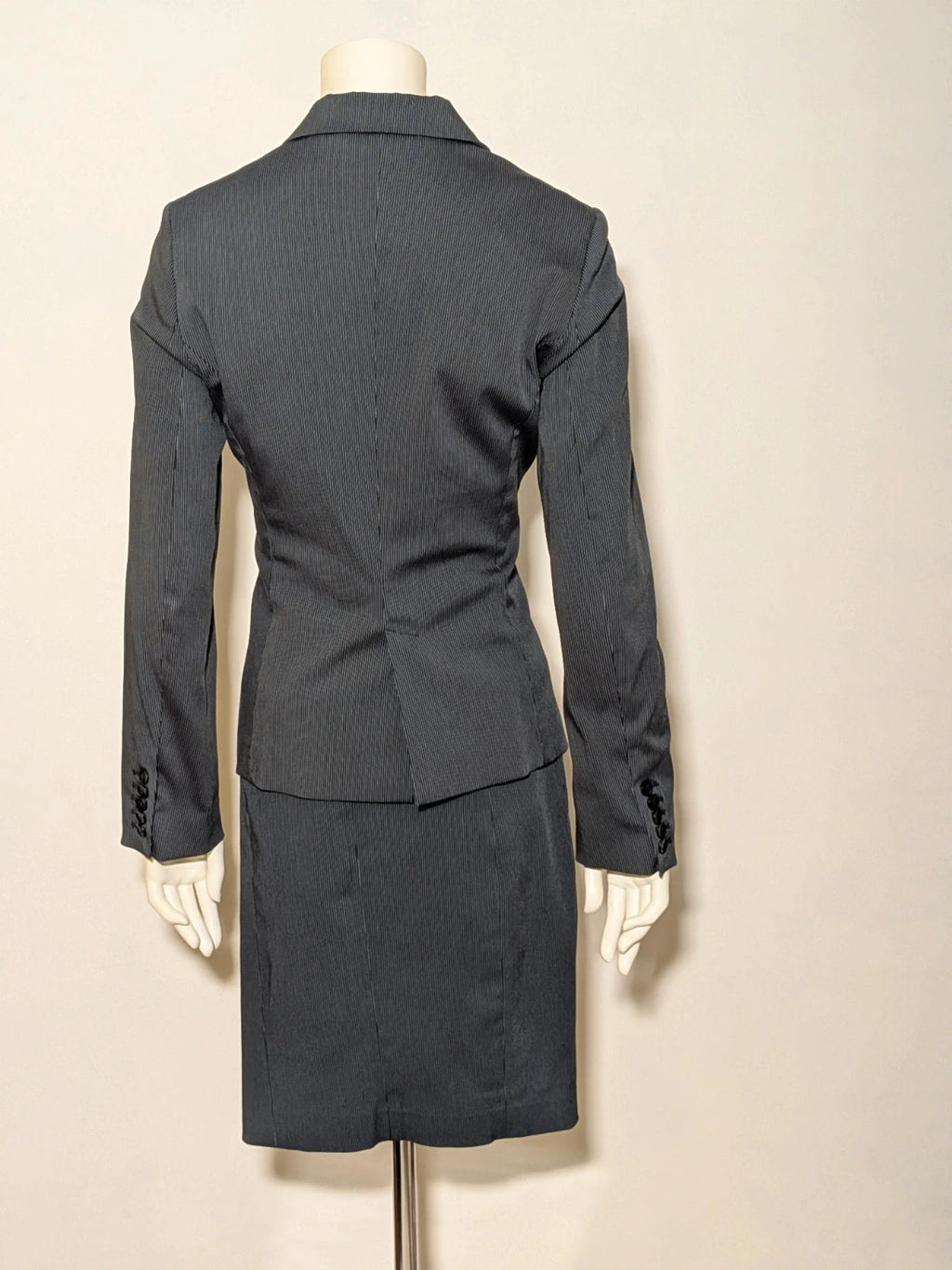 Mango Suit grey skirt suit with pinstripe pattern, single-button blazer, elegant pencil skirt.