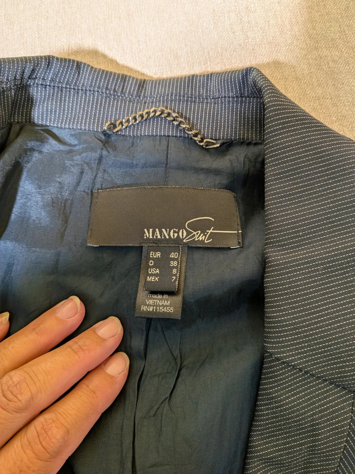 Mango Suit grey skirt suit with pinstripe pattern, single-button blazer, elegant pencil skirt.