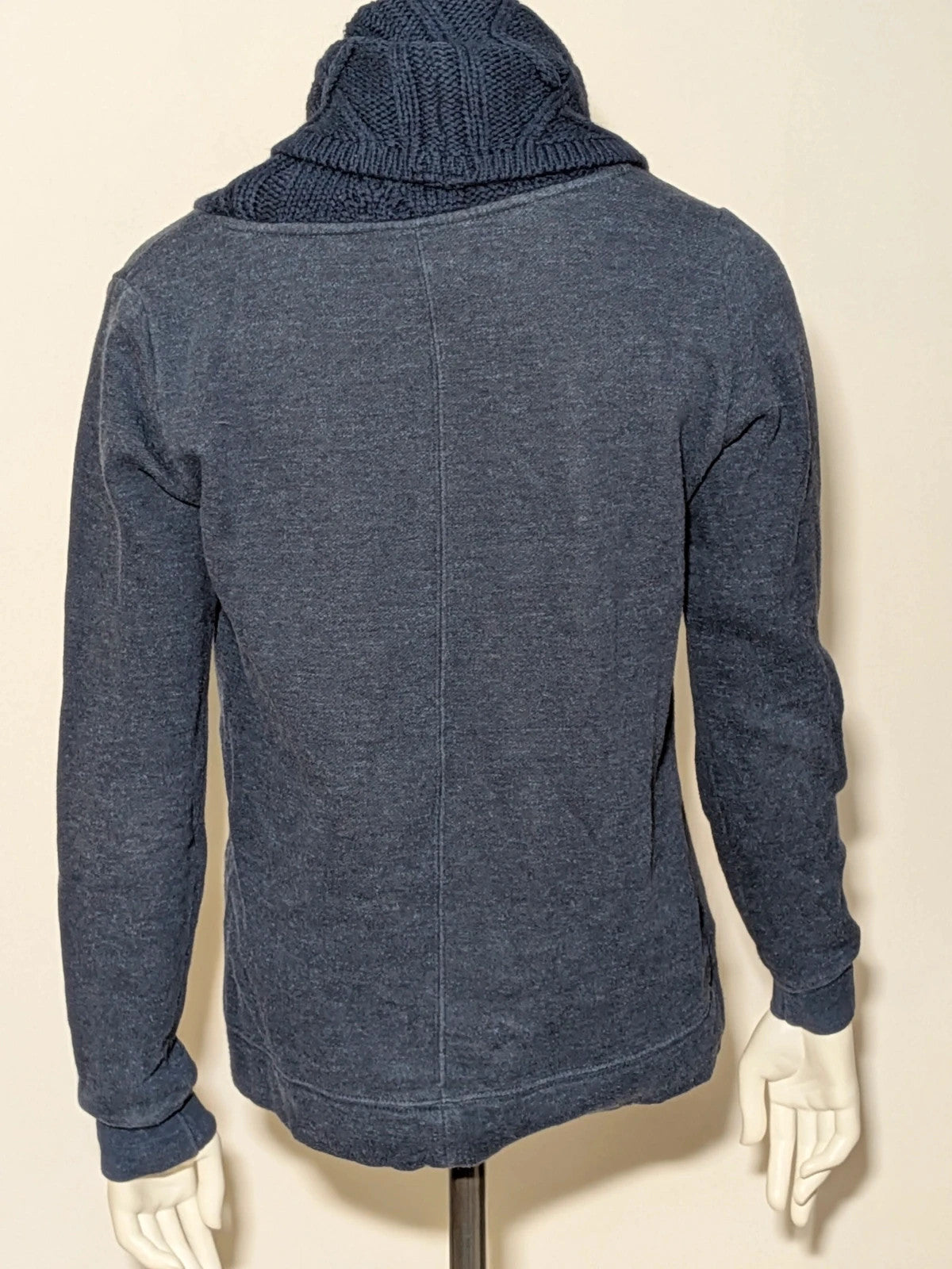 Champion navy turtleneck jumper with cable knit collar and embossed logo on front.