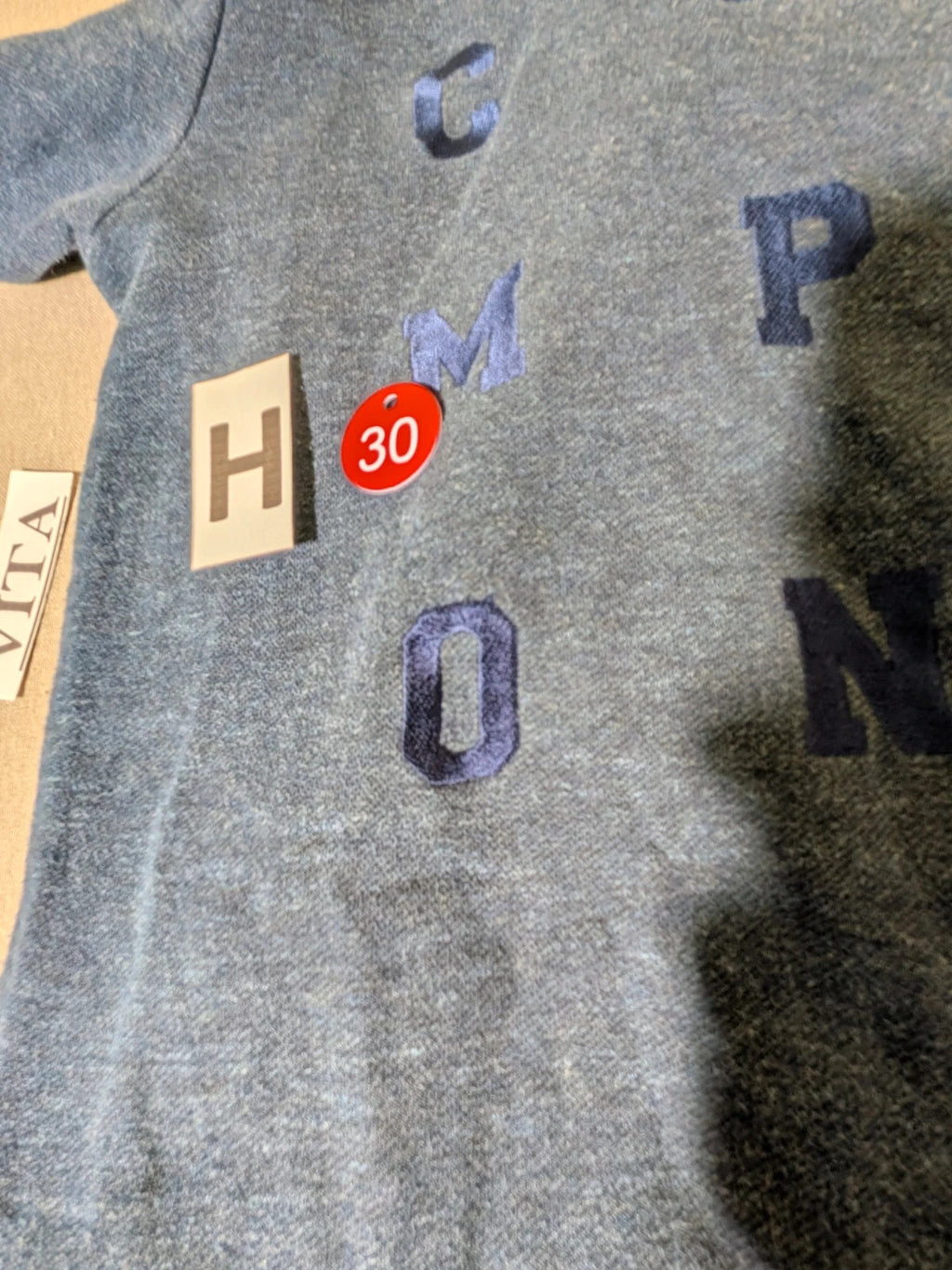 Champion navy turtleneck jumper with cable knit collar and embossed logo on front.