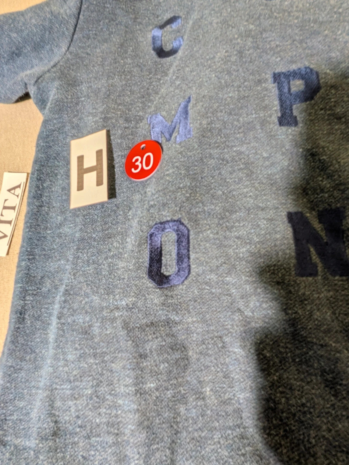 Champion navy turtleneck jumper with cable knit collar and embossed logo on front.