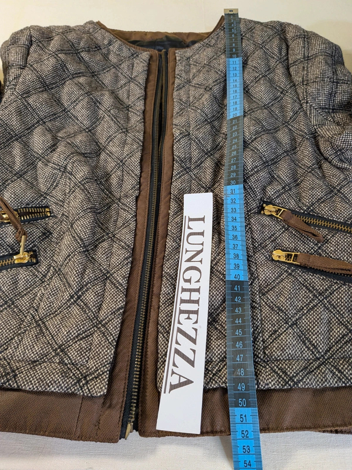 Zara Basic brown pants with flared cut, quilted jacket, gold zipper details.