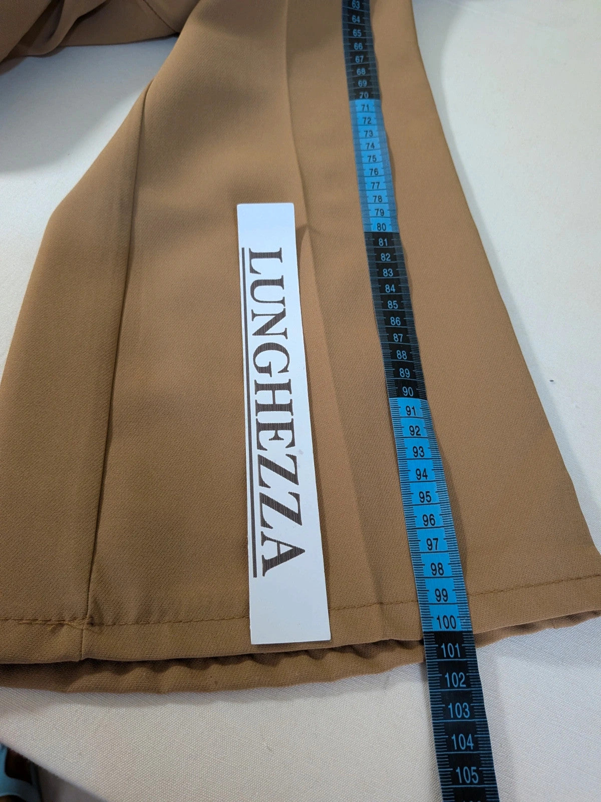 Zara Basic brown pants with flared cut, quilted jacket, gold zipper details.