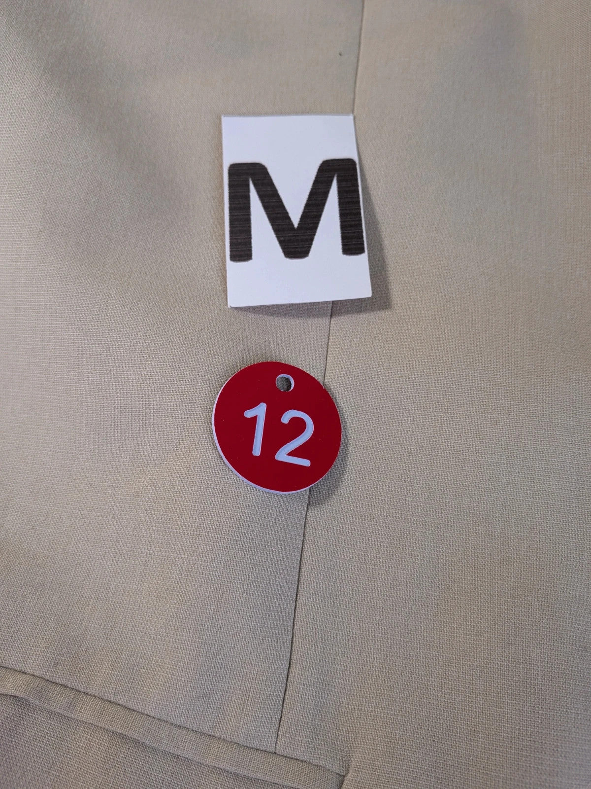 Travelmaster beige three-piece suit with classic lapel and three-button jacket design.