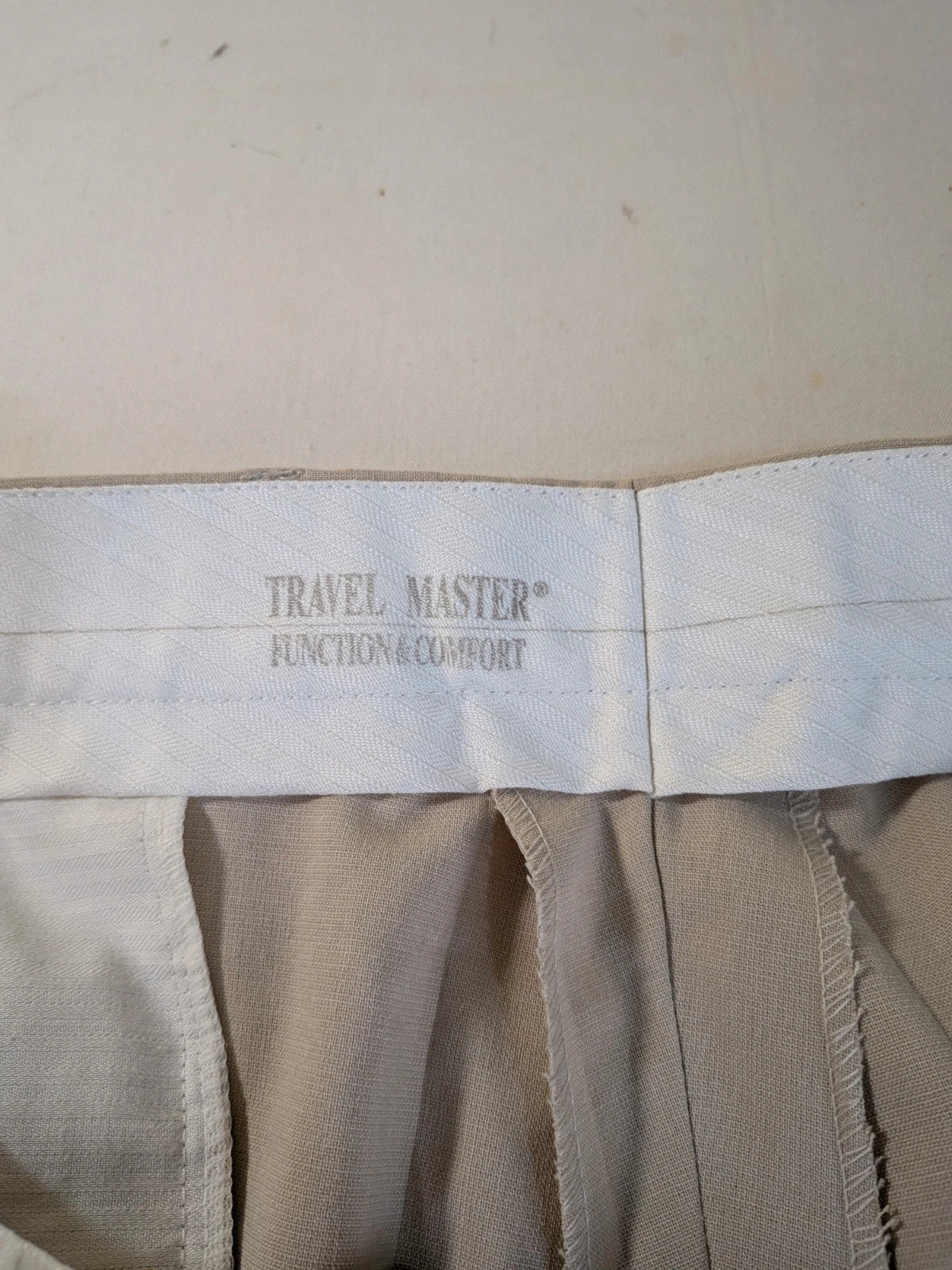 Travelmaster beige three-piece suit with classic lapel and three-button jacket design.