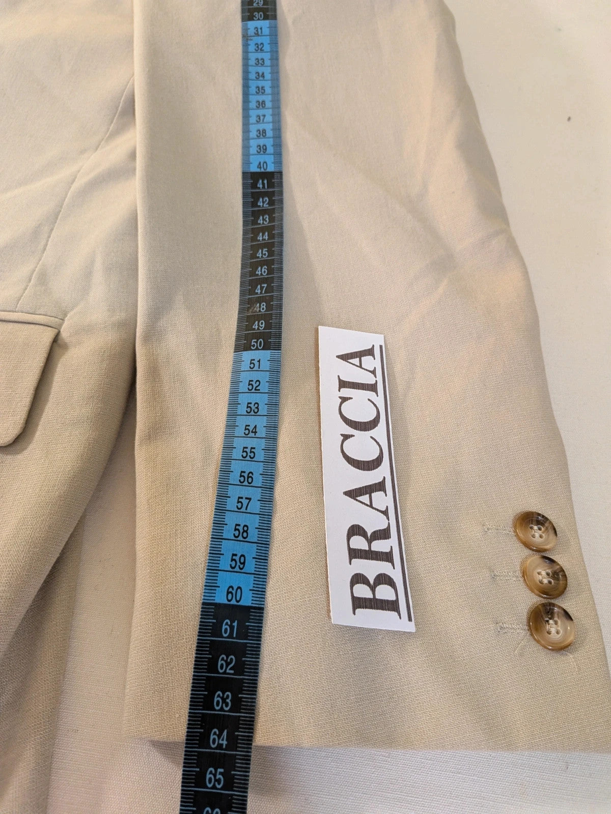 Travelmaster beige three-piece suit with classic lapel and three-button jacket design.