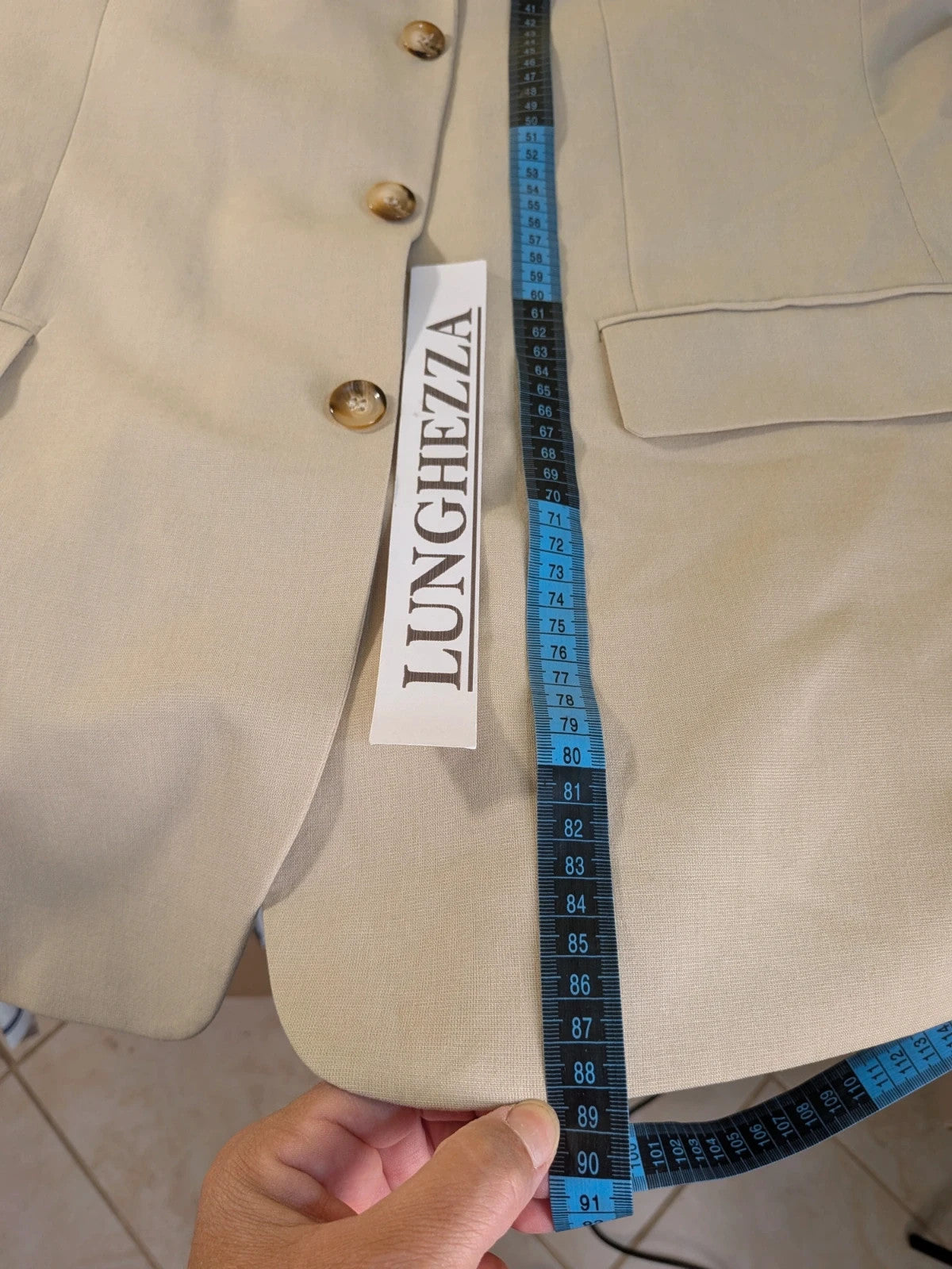 Travelmaster beige three-piece suit with classic lapel and three-button jacket design.