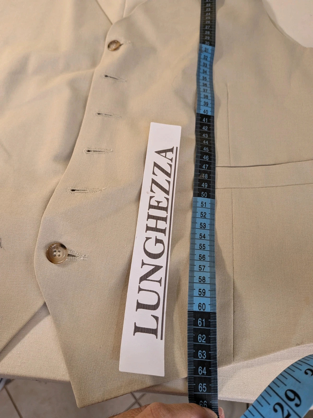 Travelmaster beige three-piece suit with classic lapel and three-button jacket design.
