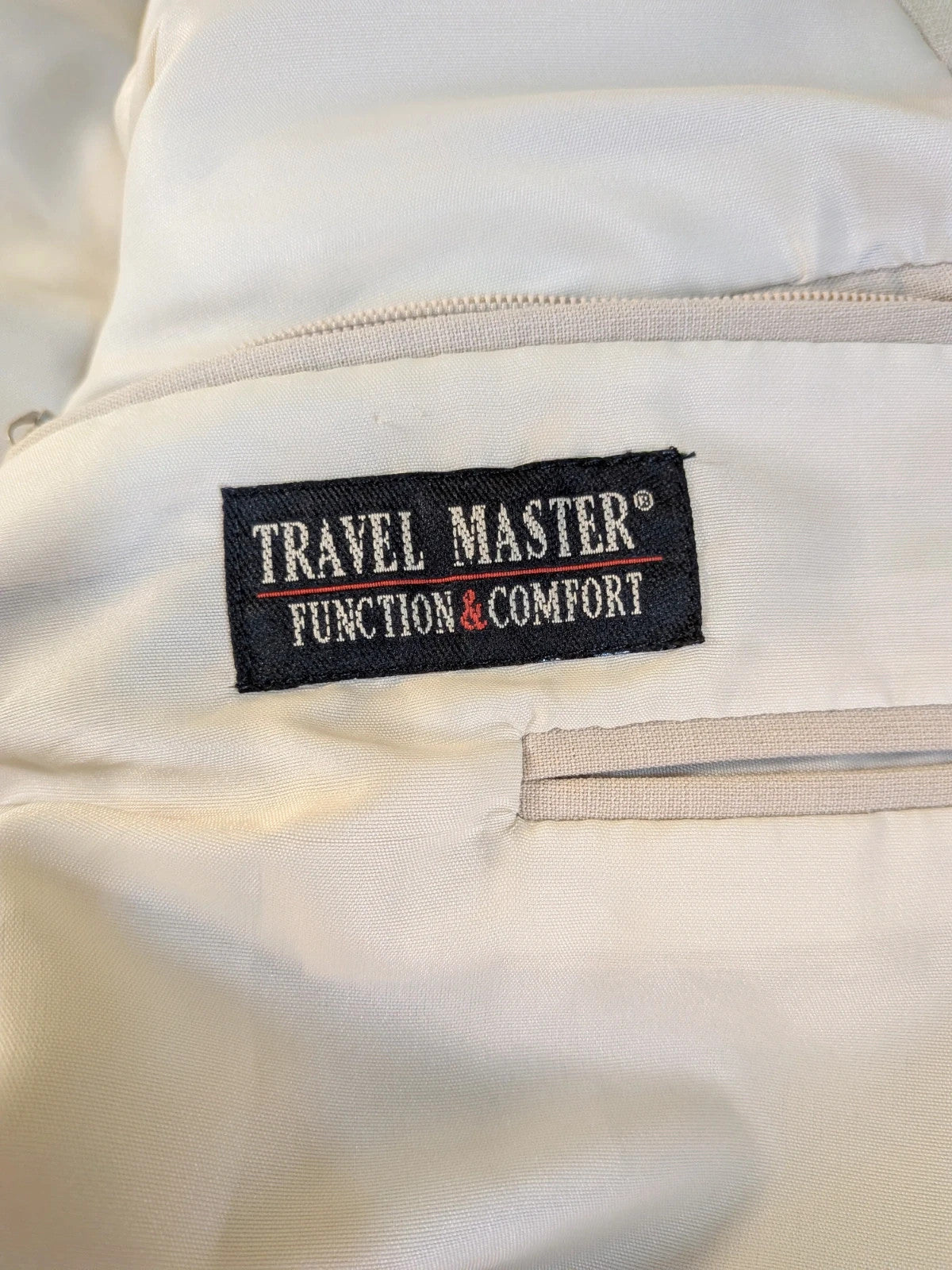 Travelmaster beige three-piece suit with classic lapel and three-button jacket design.