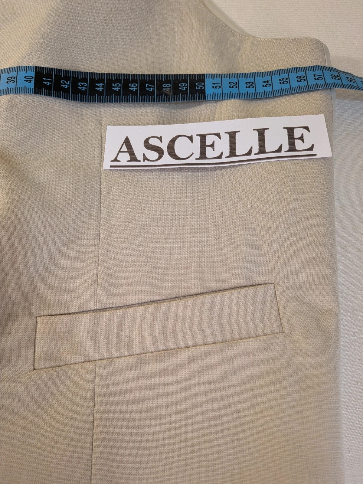 Travelmaster beige three-piece suit with classic lapel and three-button jacket design.