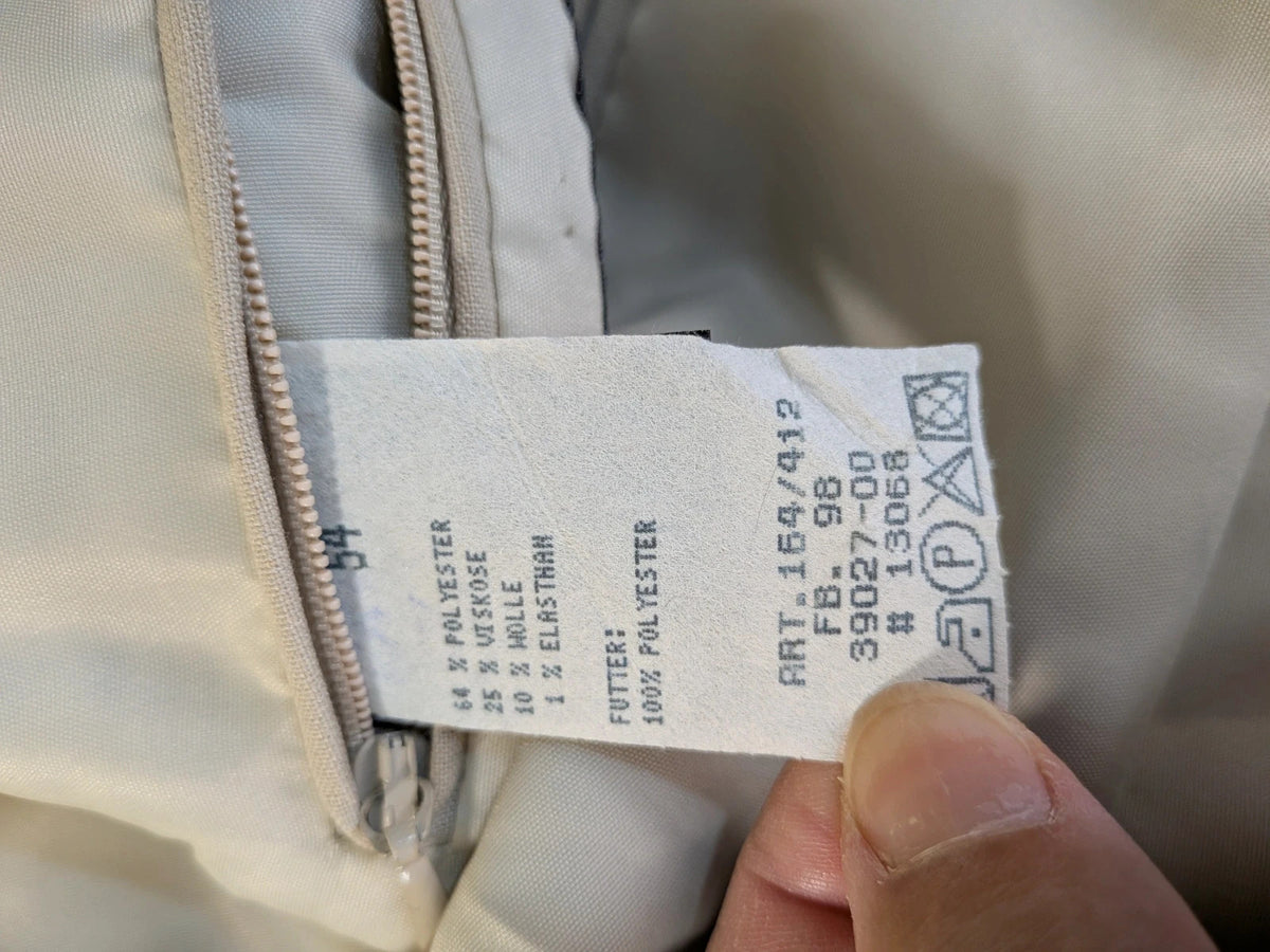 Travelmaster beige three-piece suit with classic lapel and three-button jacket design.