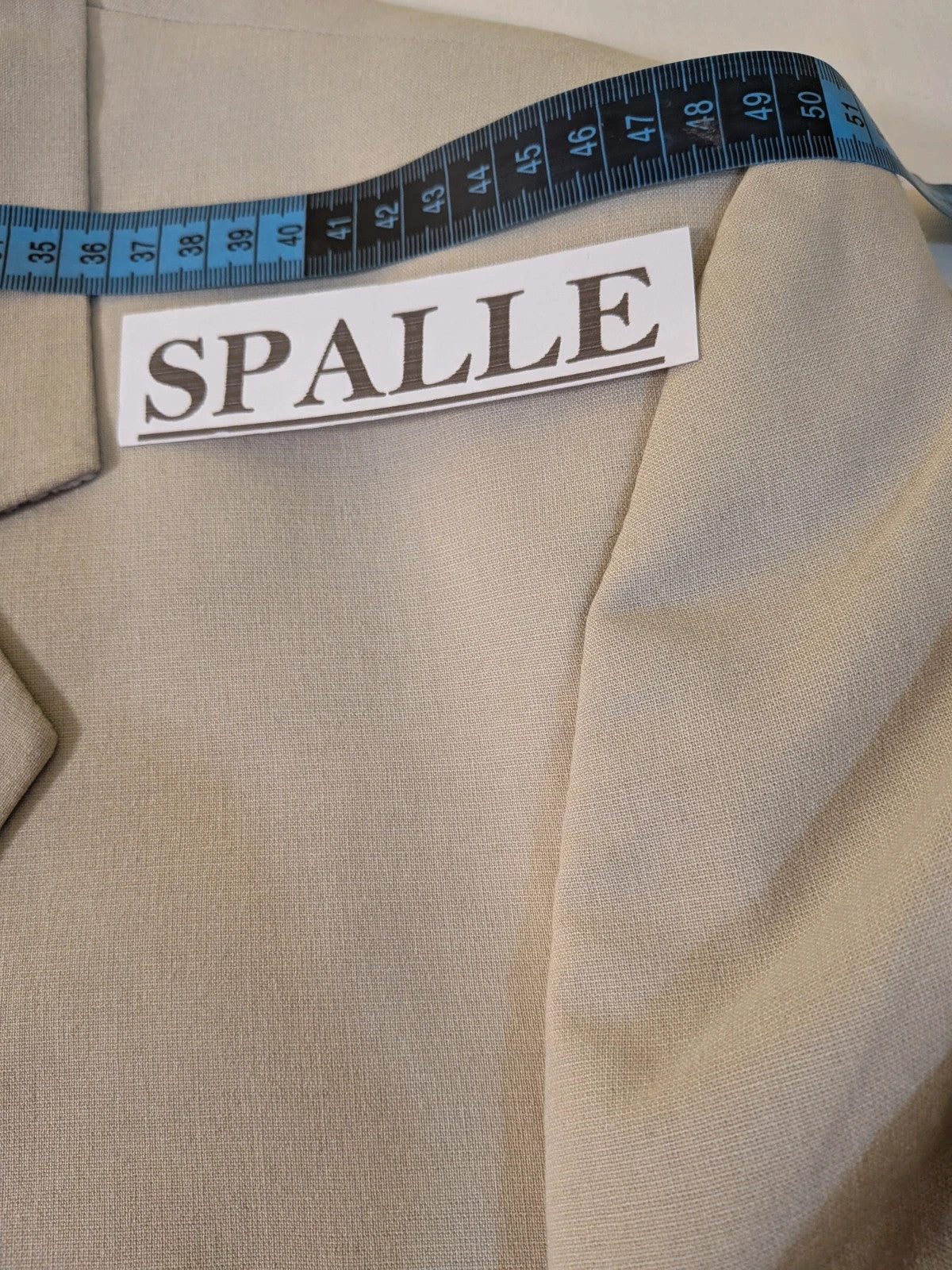 Travelmaster beige three-piece suit with classic lapel and three-button jacket design.
