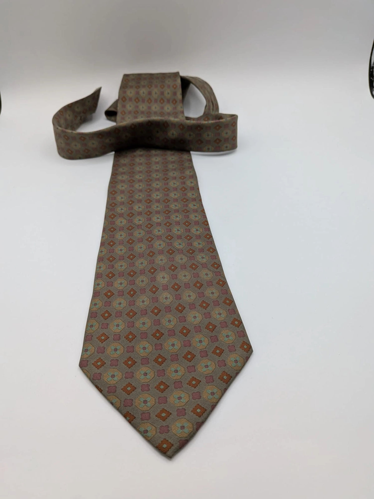 Made in Italy brown multi tie geometric floral pattern with dark blue back.