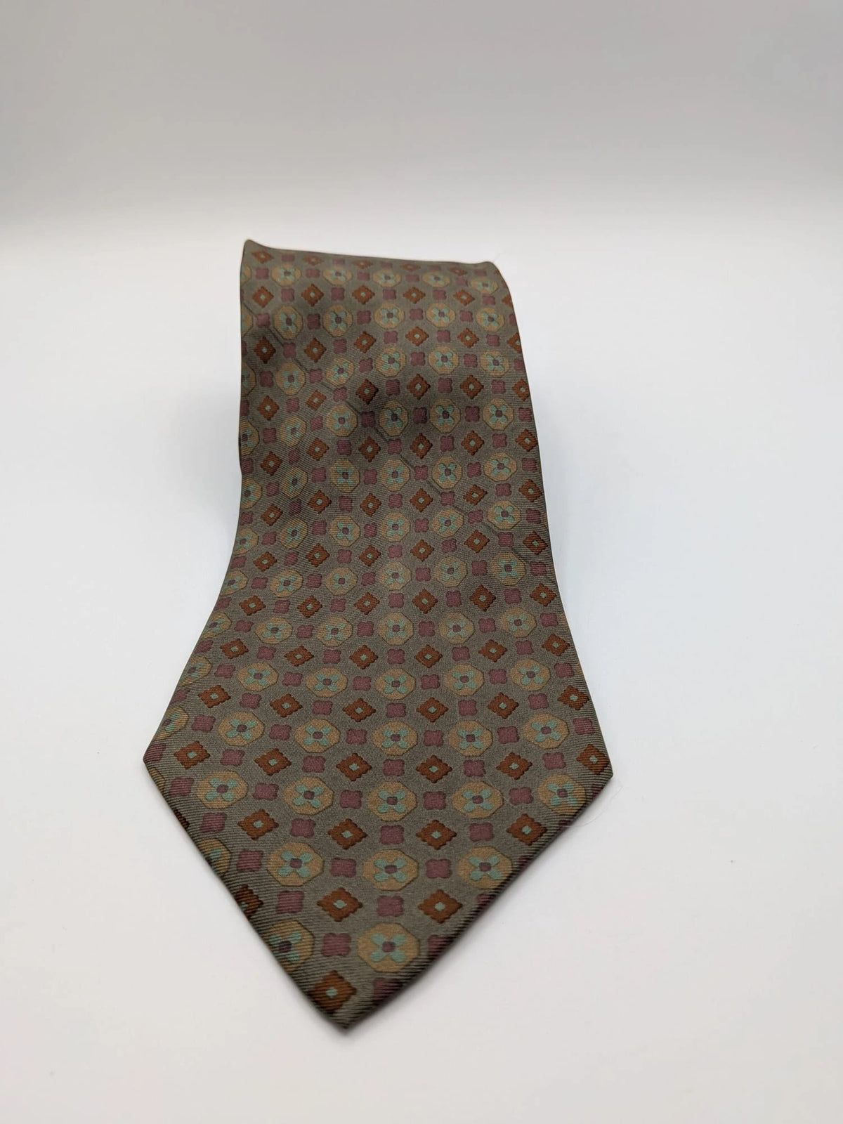 Made in Italy brown multi tie geometric floral pattern with dark blue back.