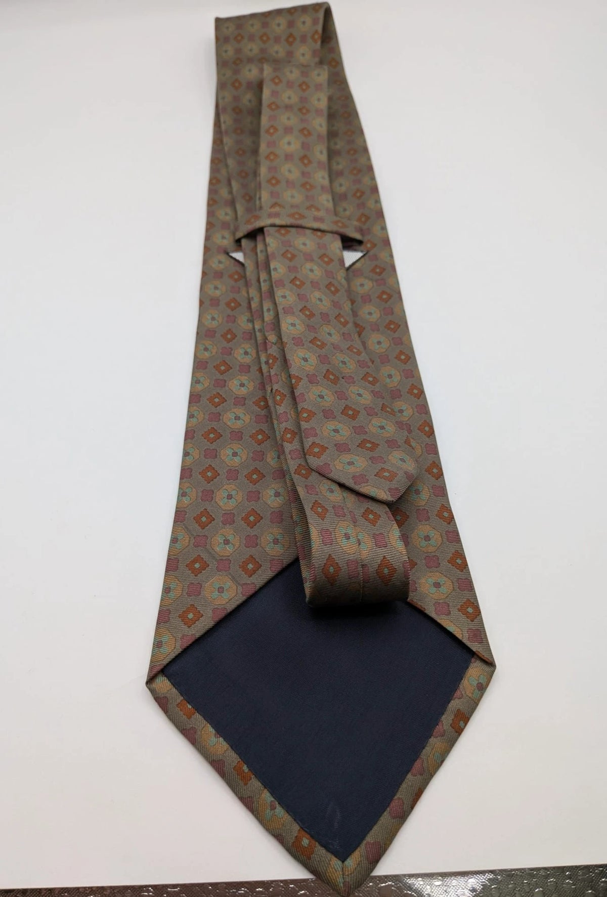Made in Italy brown multi tie geometric floral pattern with dark blue back.