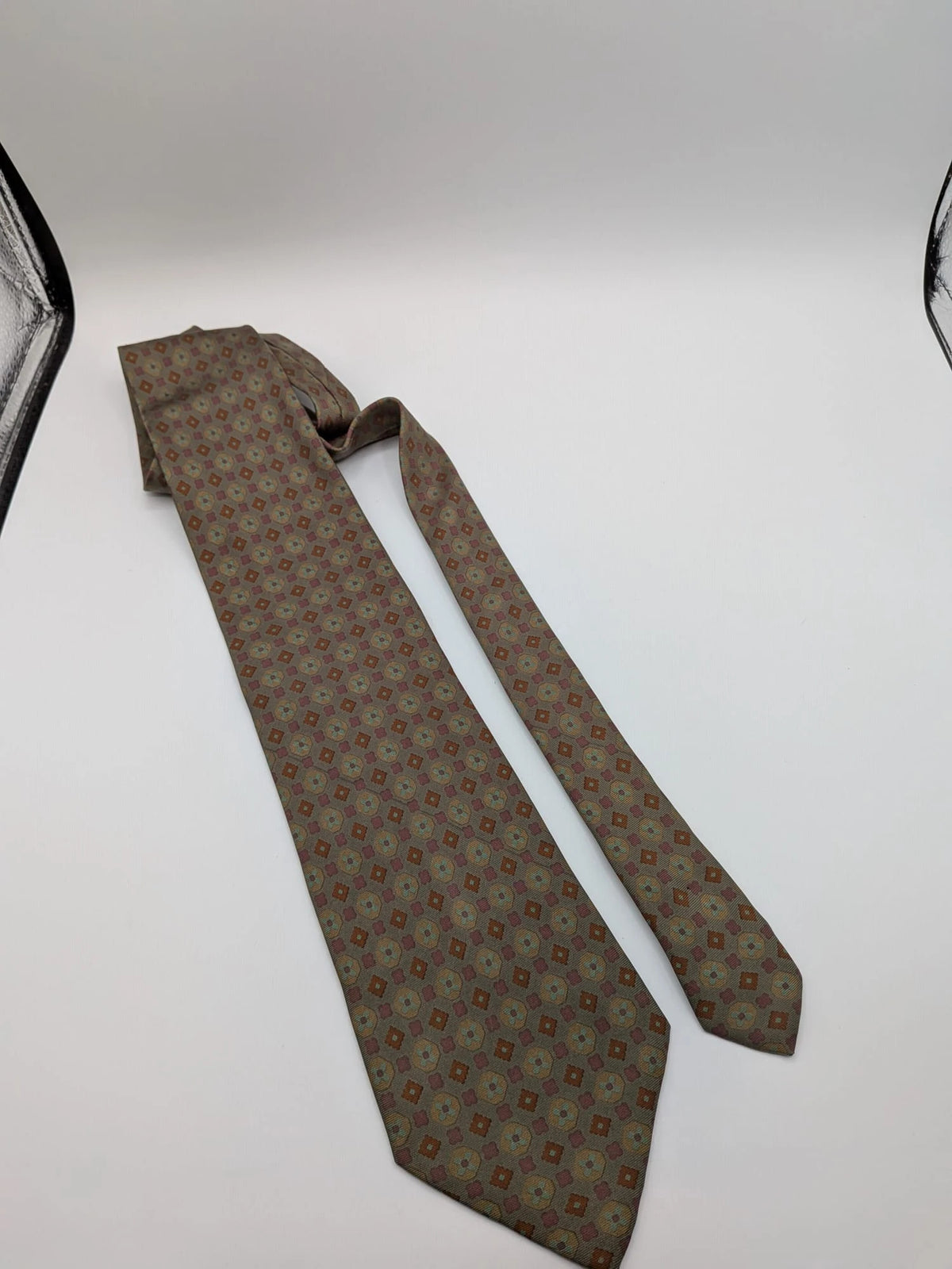 Made in Italy brown multi tie geometric floral pattern with dark blue back.