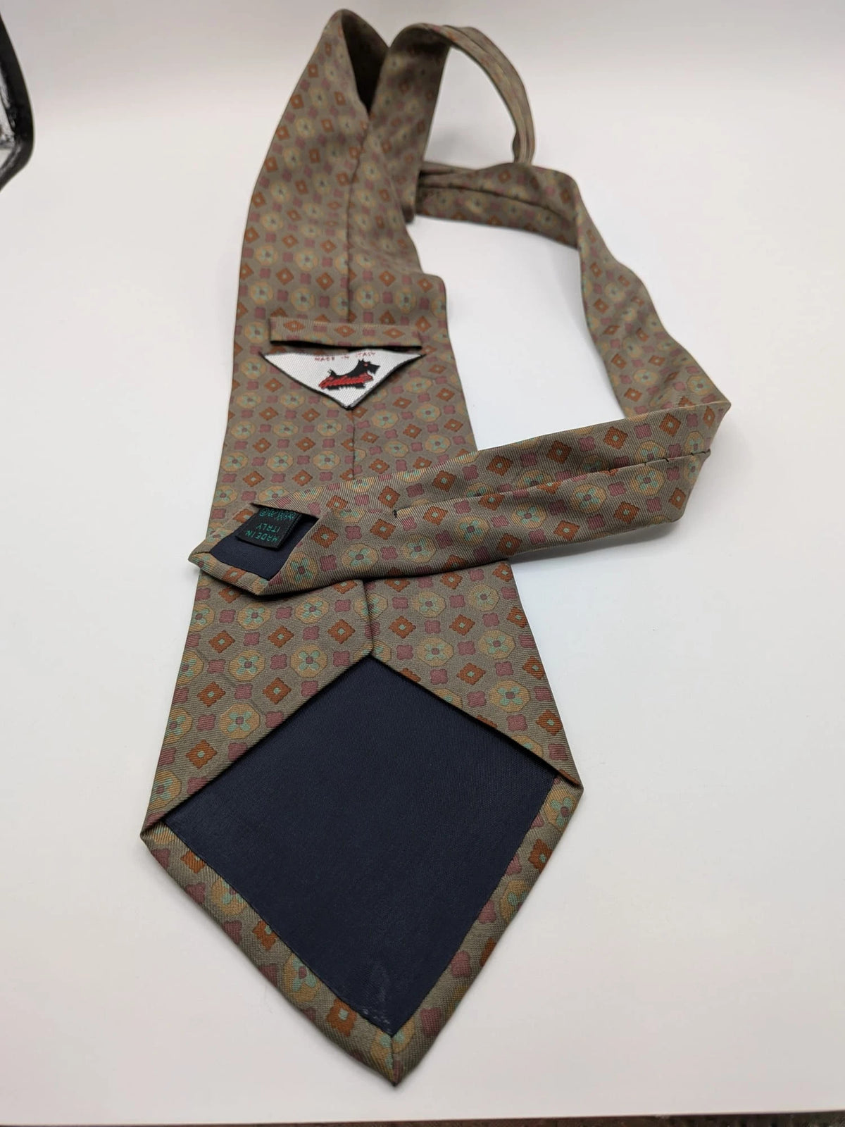 Made in Italy brown multi tie geometric floral pattern with dark blue back.