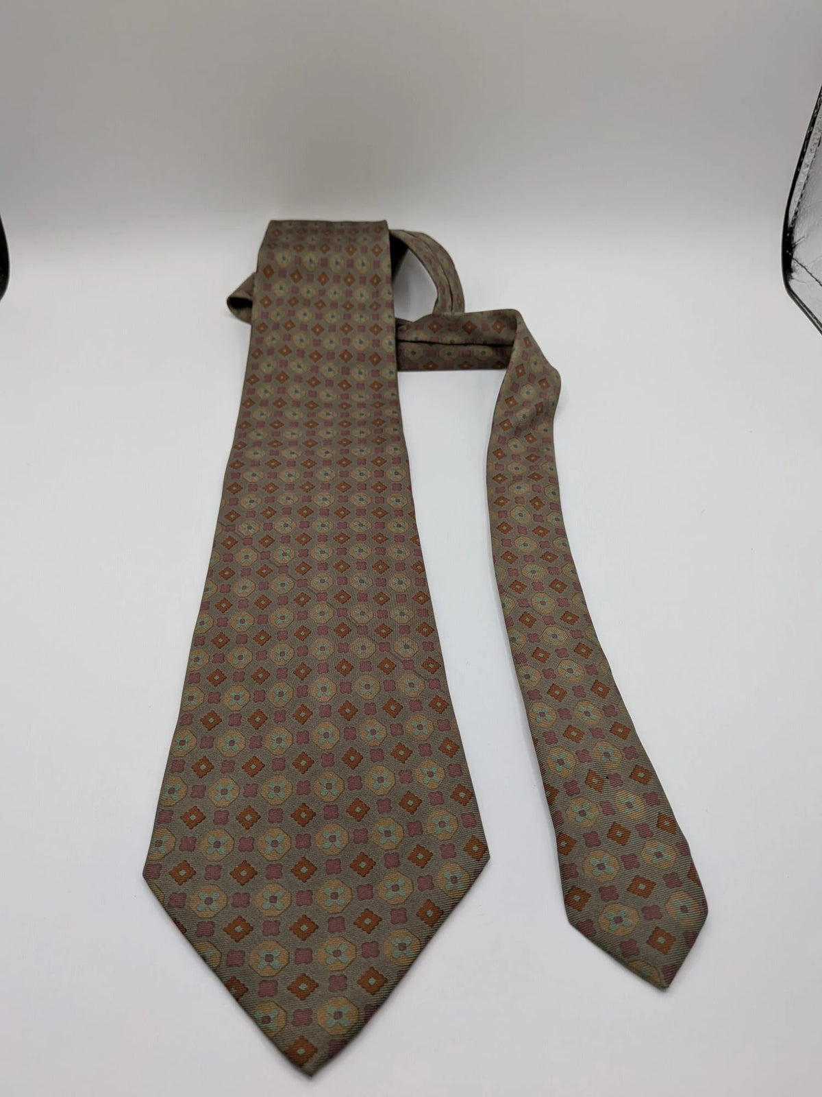 Made in Italy brown multi tie geometric floral pattern with dark blue back.