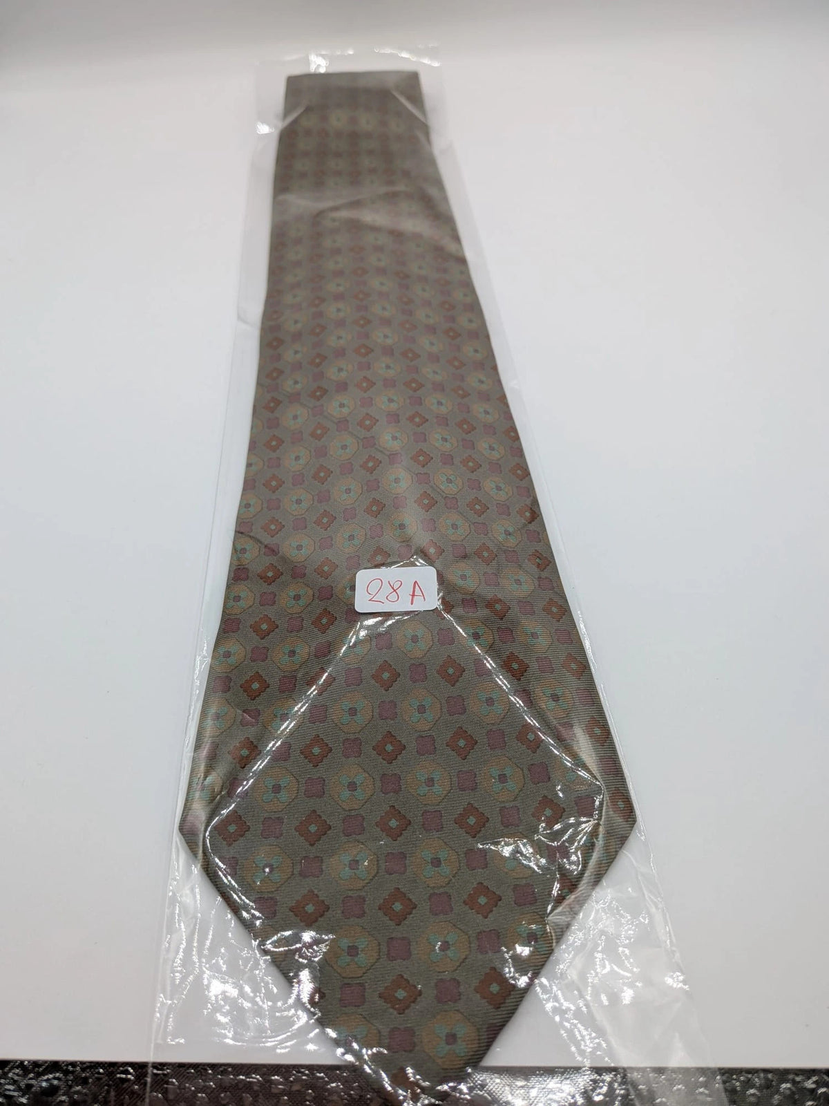 Made in Italy brown multi tie geometric floral pattern with dark blue back.
