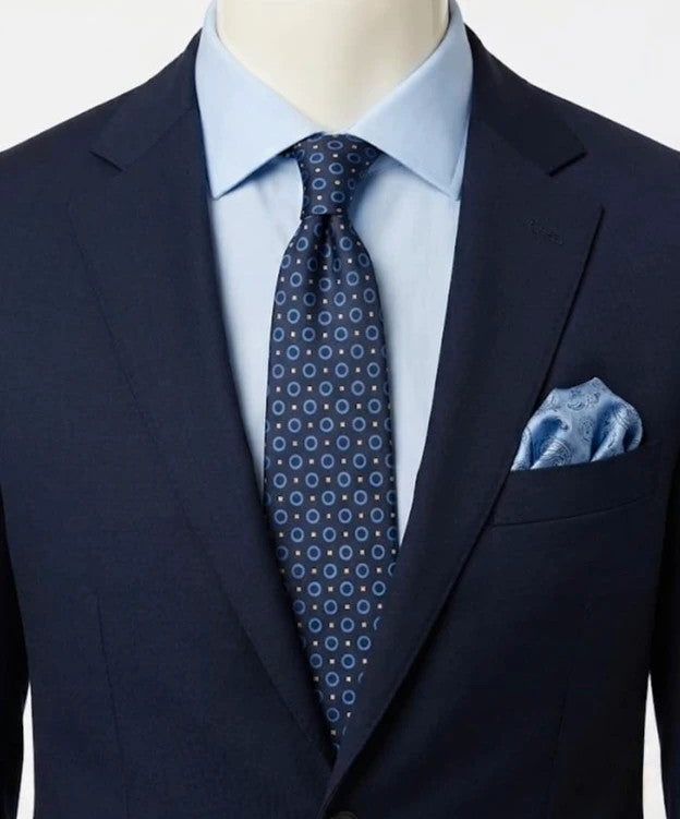 Milano navy tie geometric pattern with light blue rings and beige motifs, 100% silk.