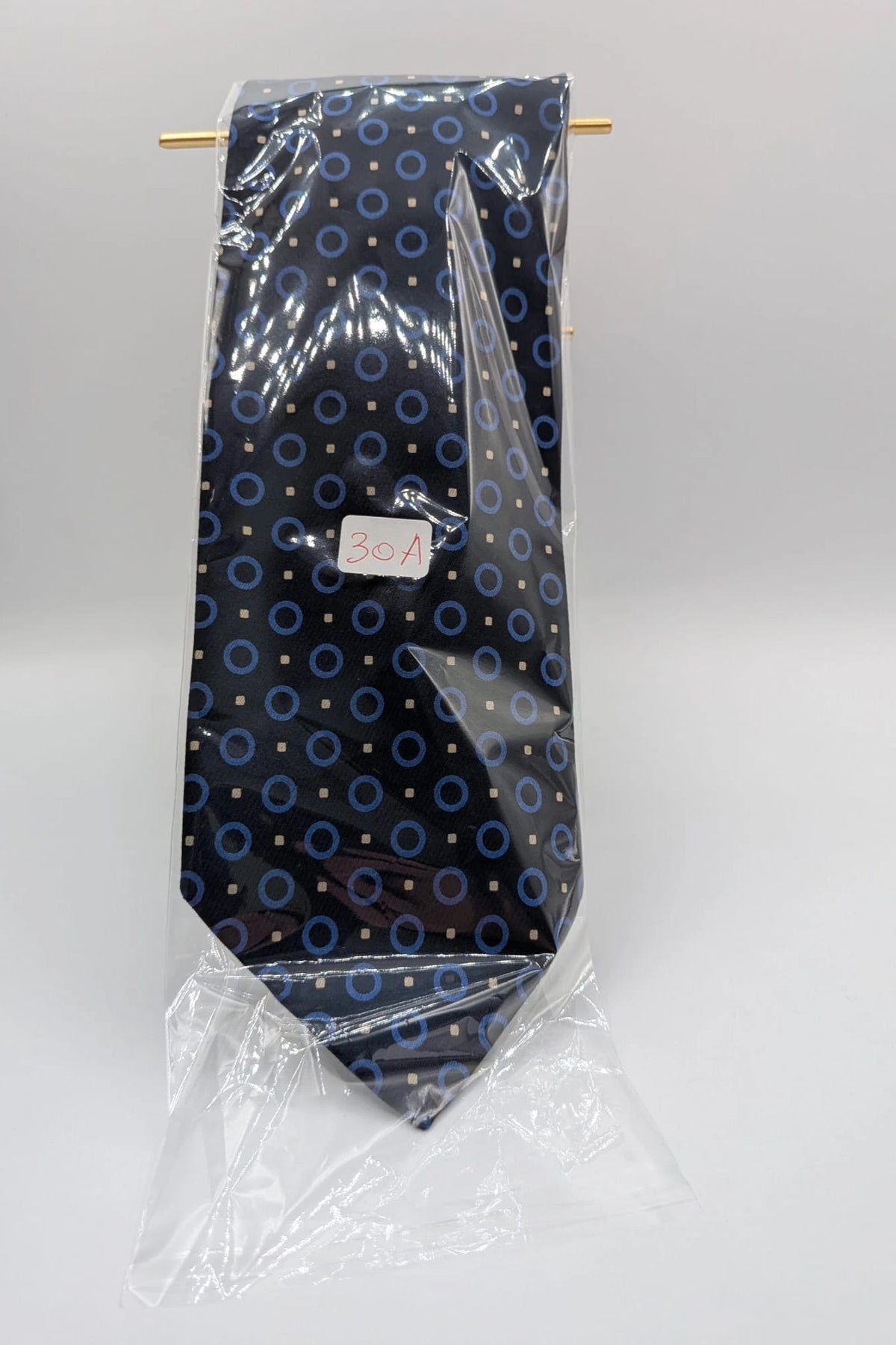 Milano navy tie geometric pattern with light blue rings and beige motifs, 100% silk.