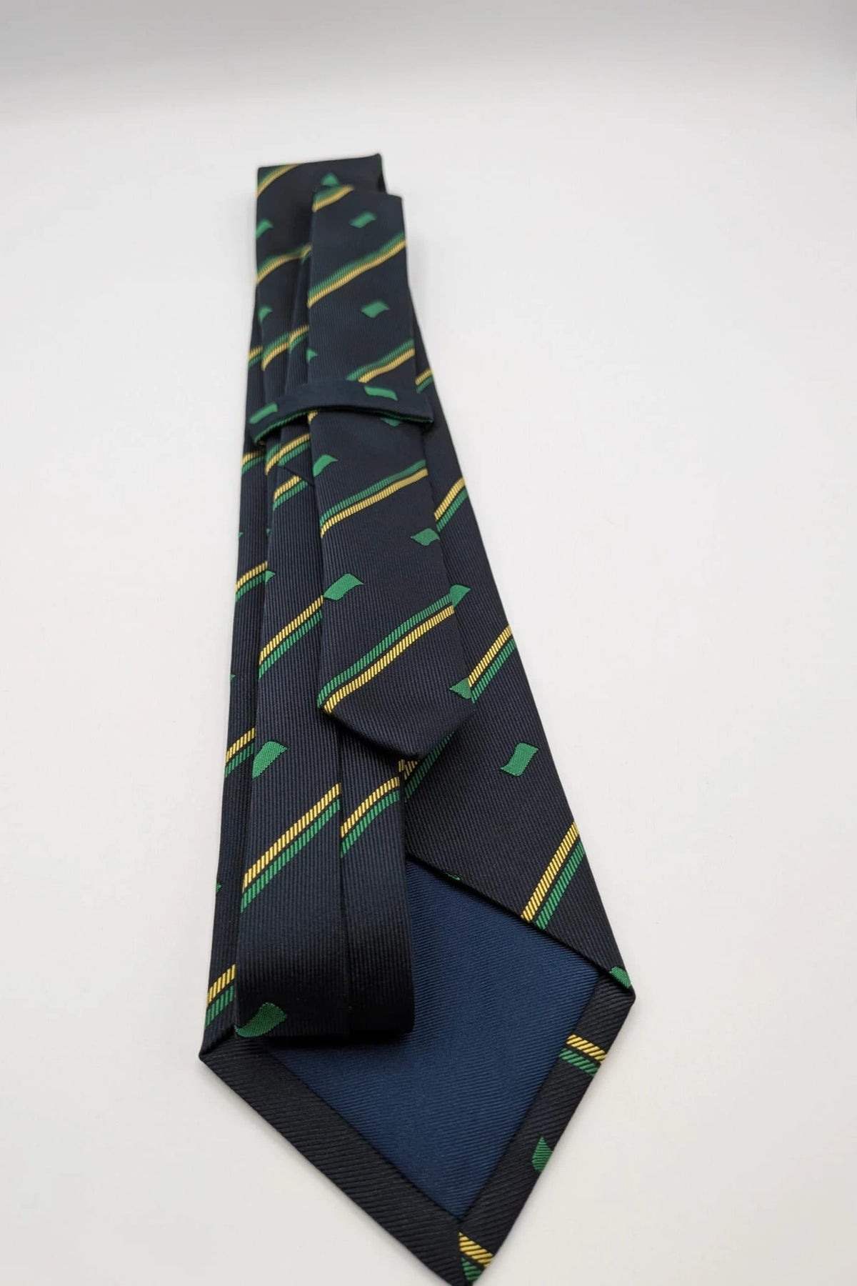 Norda tie navy blue with green and yellow diagonal stripes and geometric patterns.