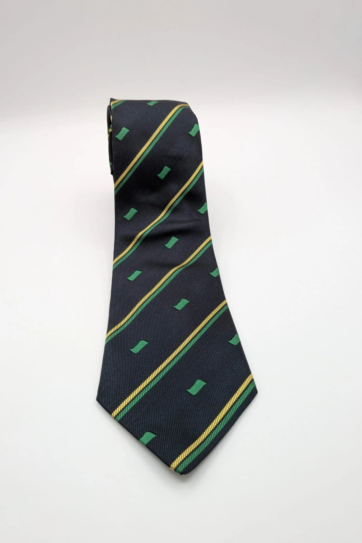 Norda tie navy blue with green and yellow diagonal stripes and geometric patterns.