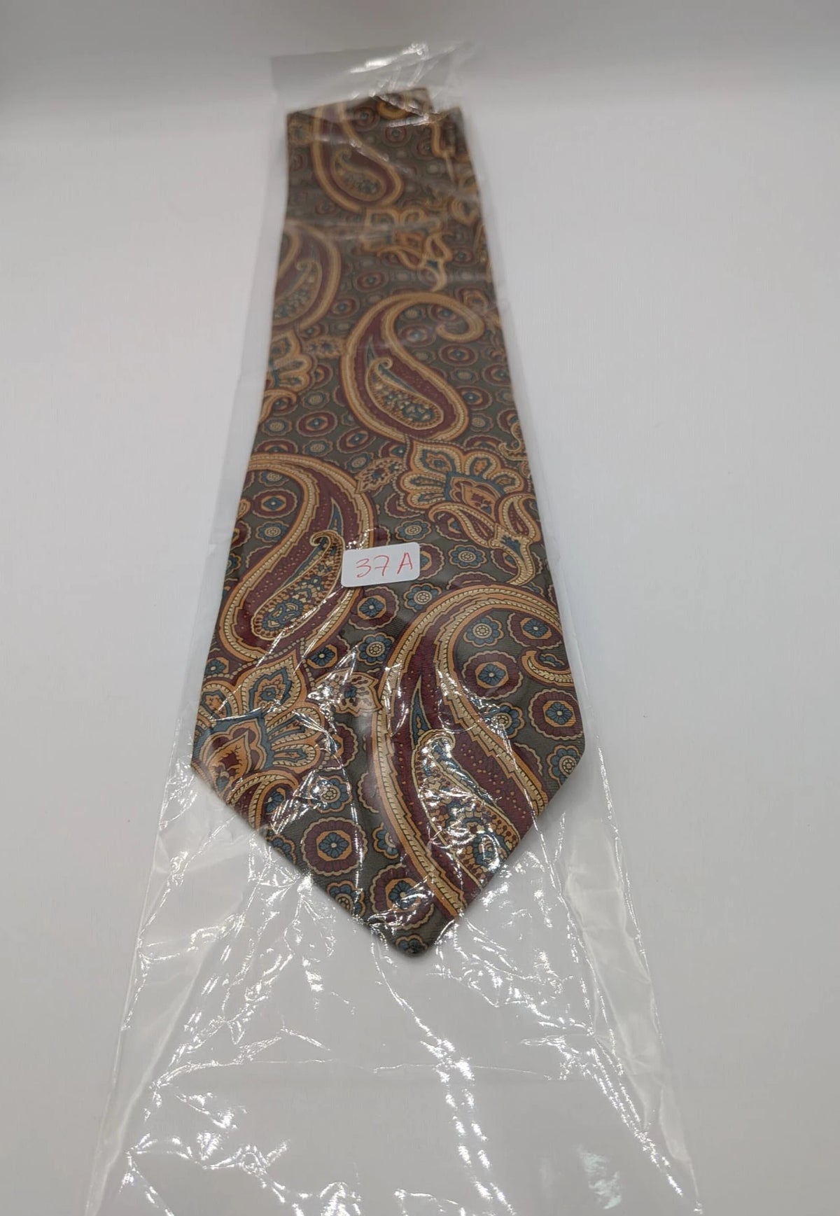 Uomo brown paisley tie in crèpe de chine with gold, blue, and burgundy patterns.