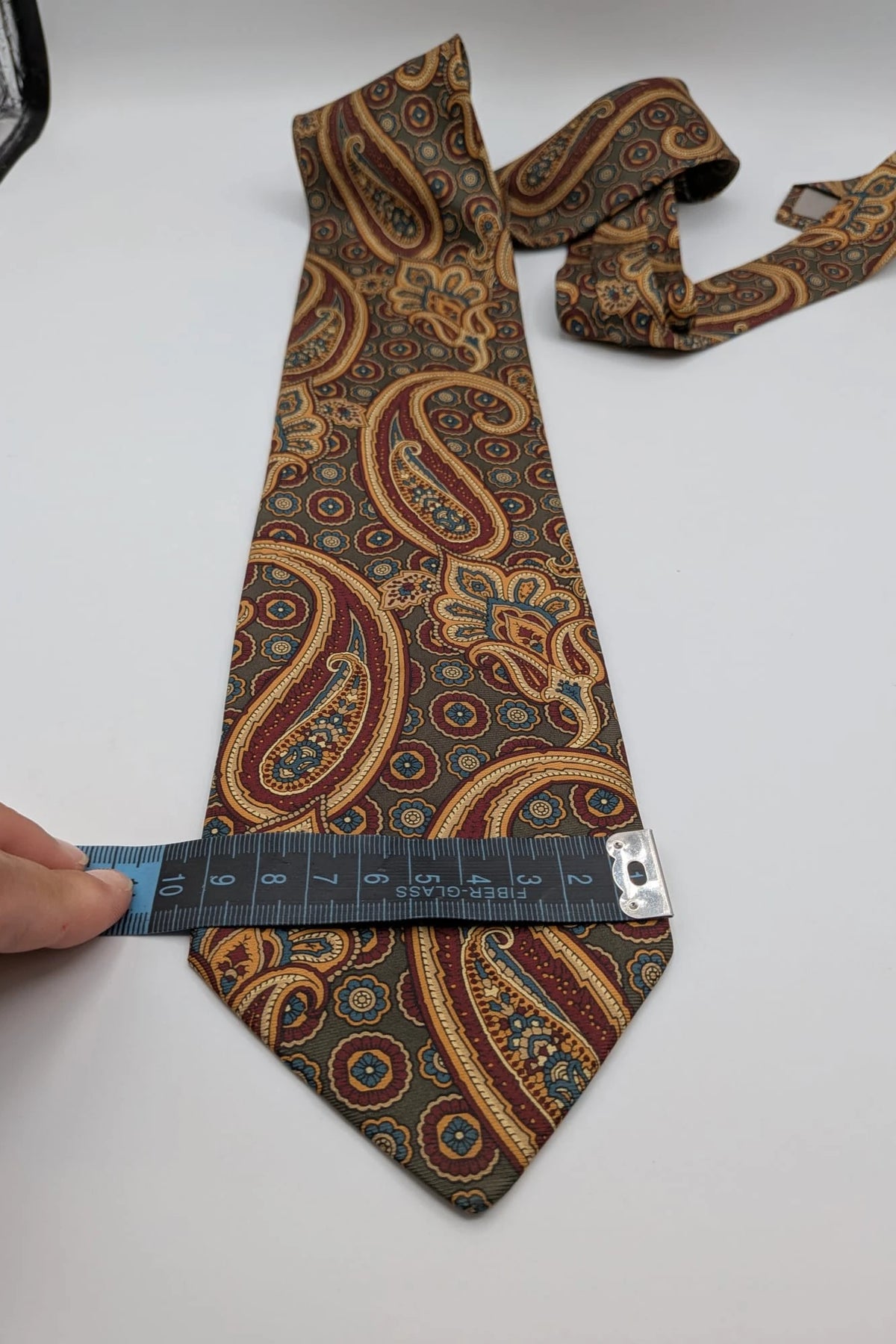 Uomo brown paisley tie in crèpe de chine with gold, blue, and burgundy patterns.