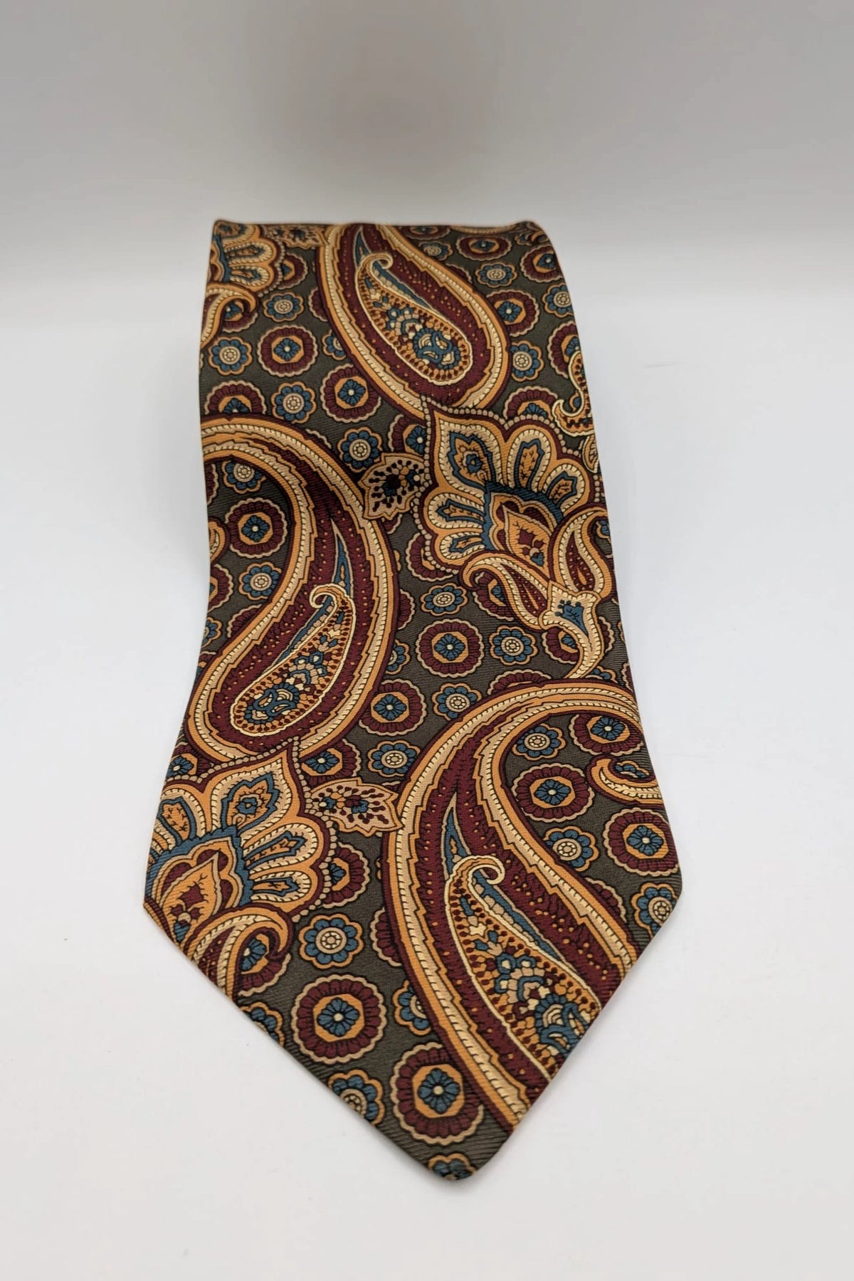Uomo brown paisley tie in crèpe de chine with gold, blue, and burgundy patterns.
