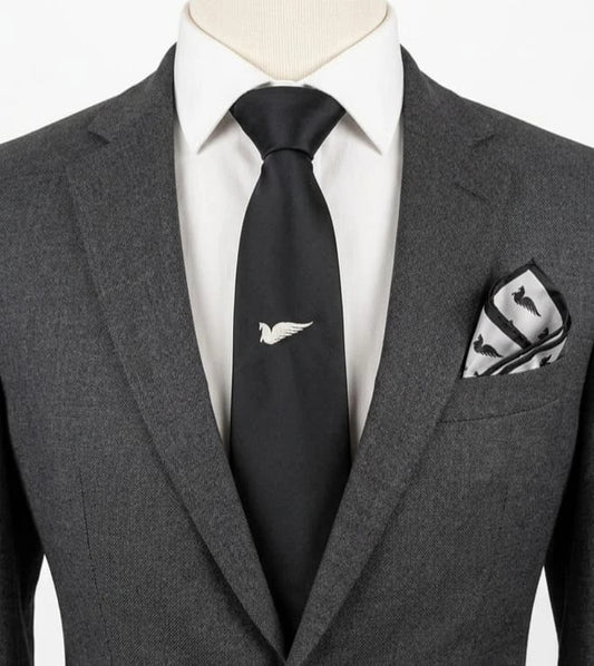 Uomo black tie with embroidered white logo, 100% polyester, Made in Italy.