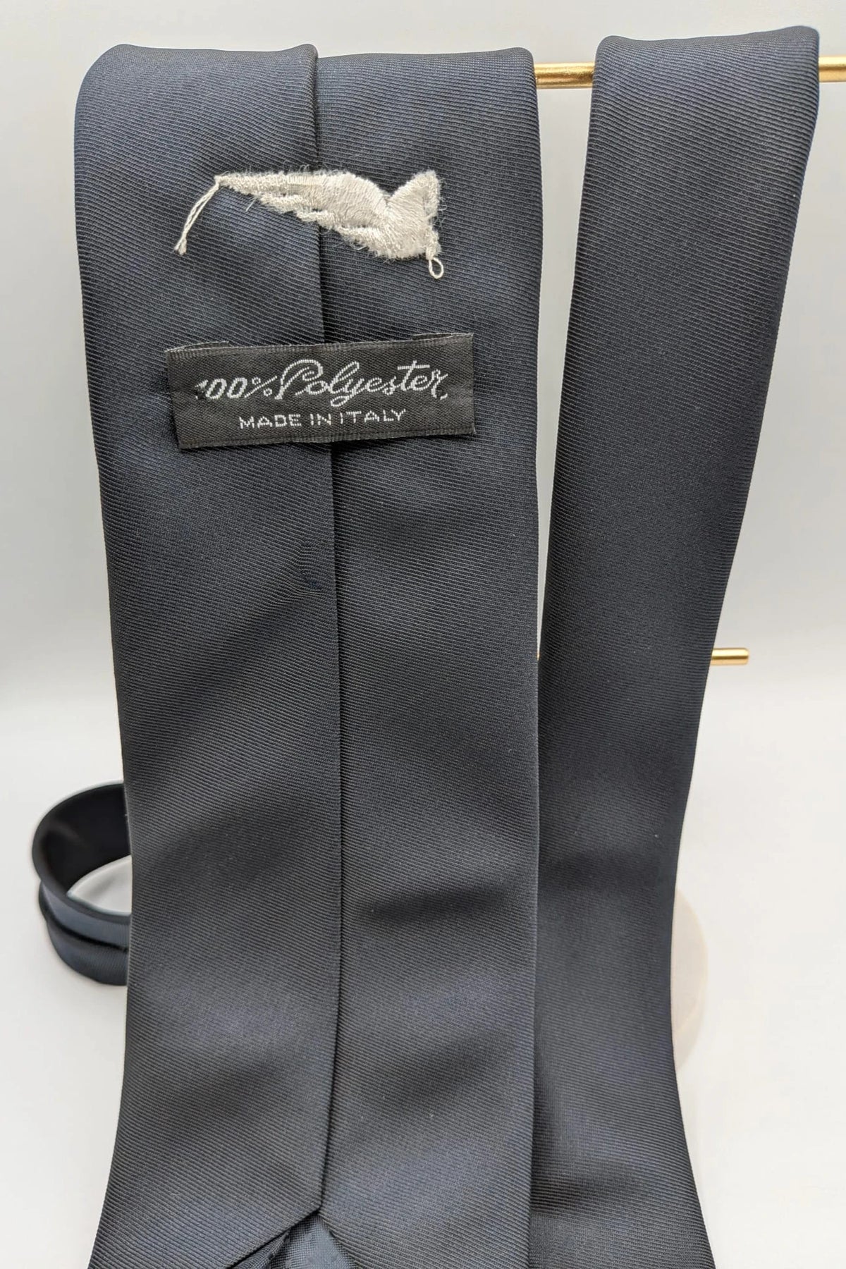 Uomo black tie with embroidered white logo, 100% polyester, Made in Italy.