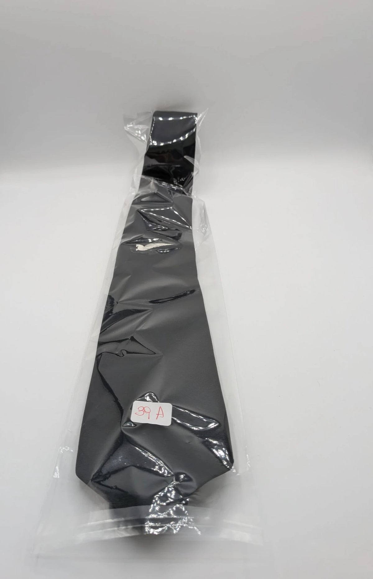 Uomo black tie with embroidered white logo, 100% polyester, Made in Italy.