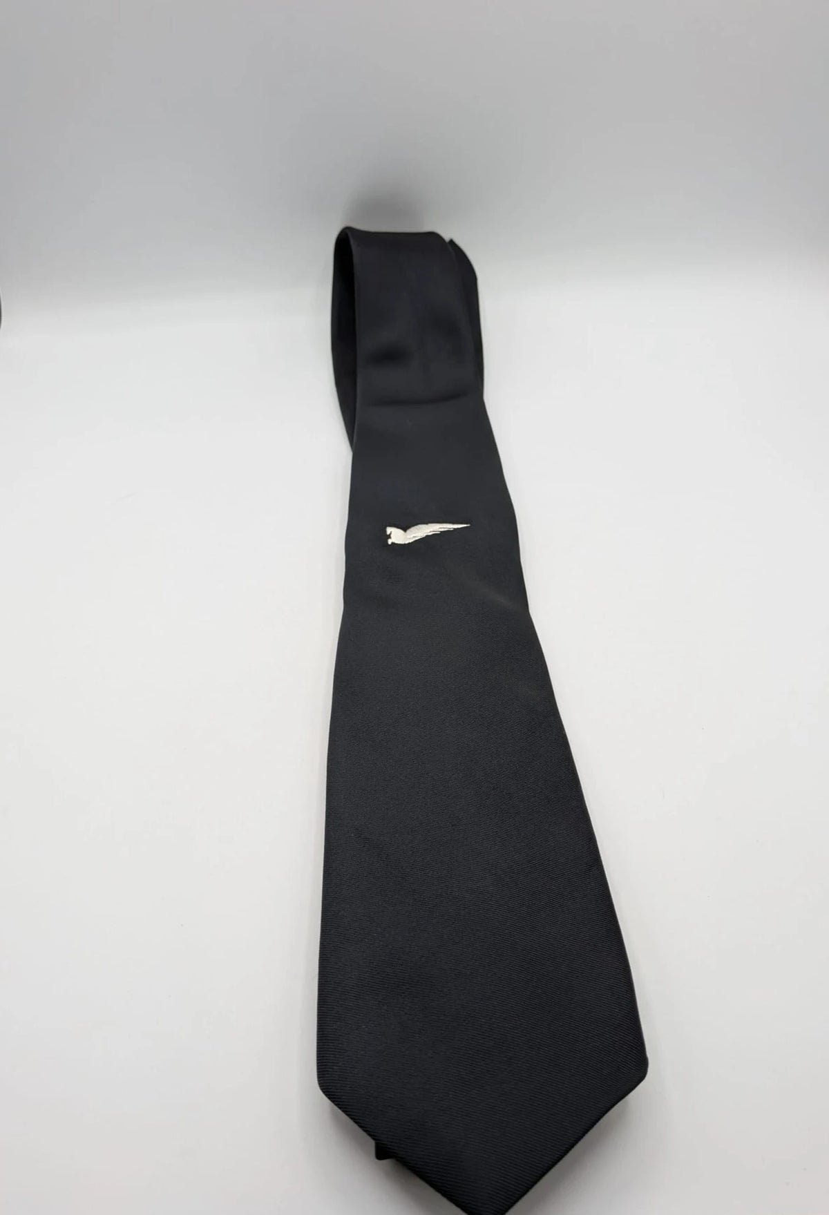Uomo black tie with embroidered white logo, 100% polyester, Made in Italy.