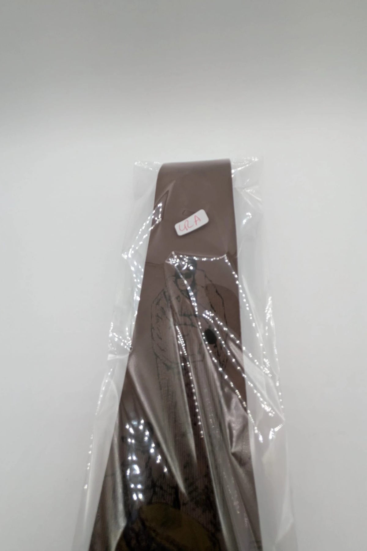 Uomo brown tie vintage illustrated pattern with blue, bordeaux, and ochre details.